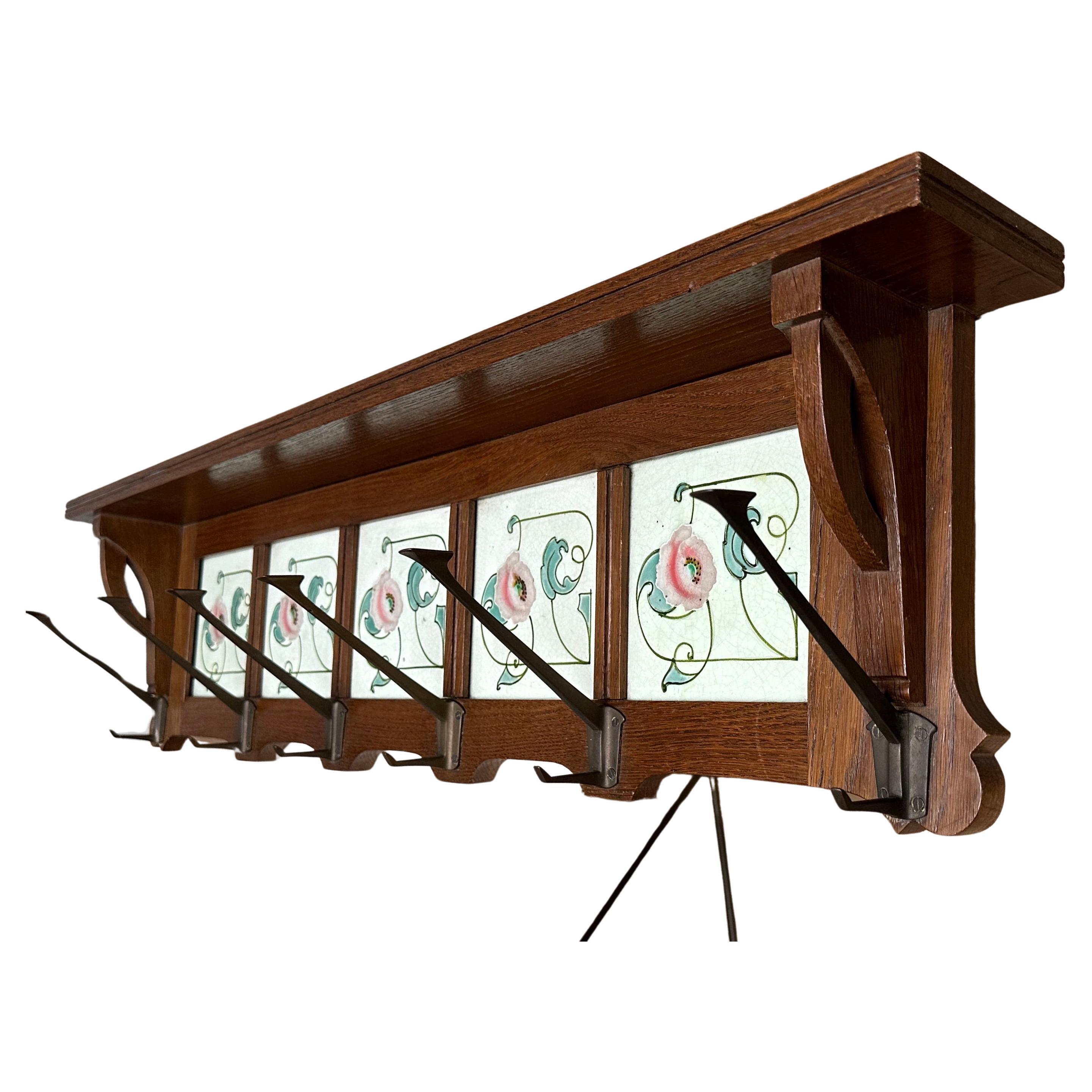 Stunning design and good condition, hand crafted oakwood wall coat-rack with unique tiles.

This rare and highly stylish Art Nouveau / Jugendstil coat rack is entirely original and in very good condition. Its large size and practical design makes it
