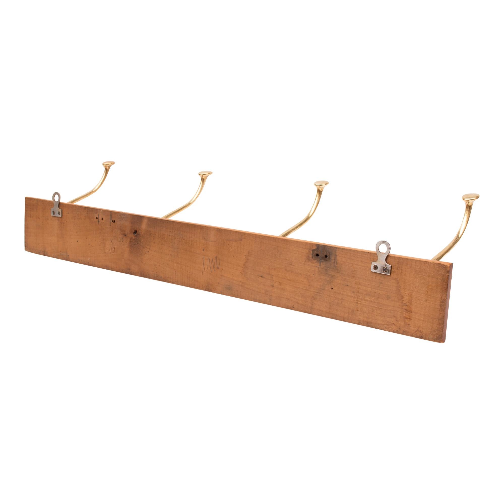 Beautiful small Art Nouveau coat rail made of cherrywood with four hooks made of solid brass.
The hooks are reminiscent of Adolf Loos' designs for the Cafe Capua in Vienna.