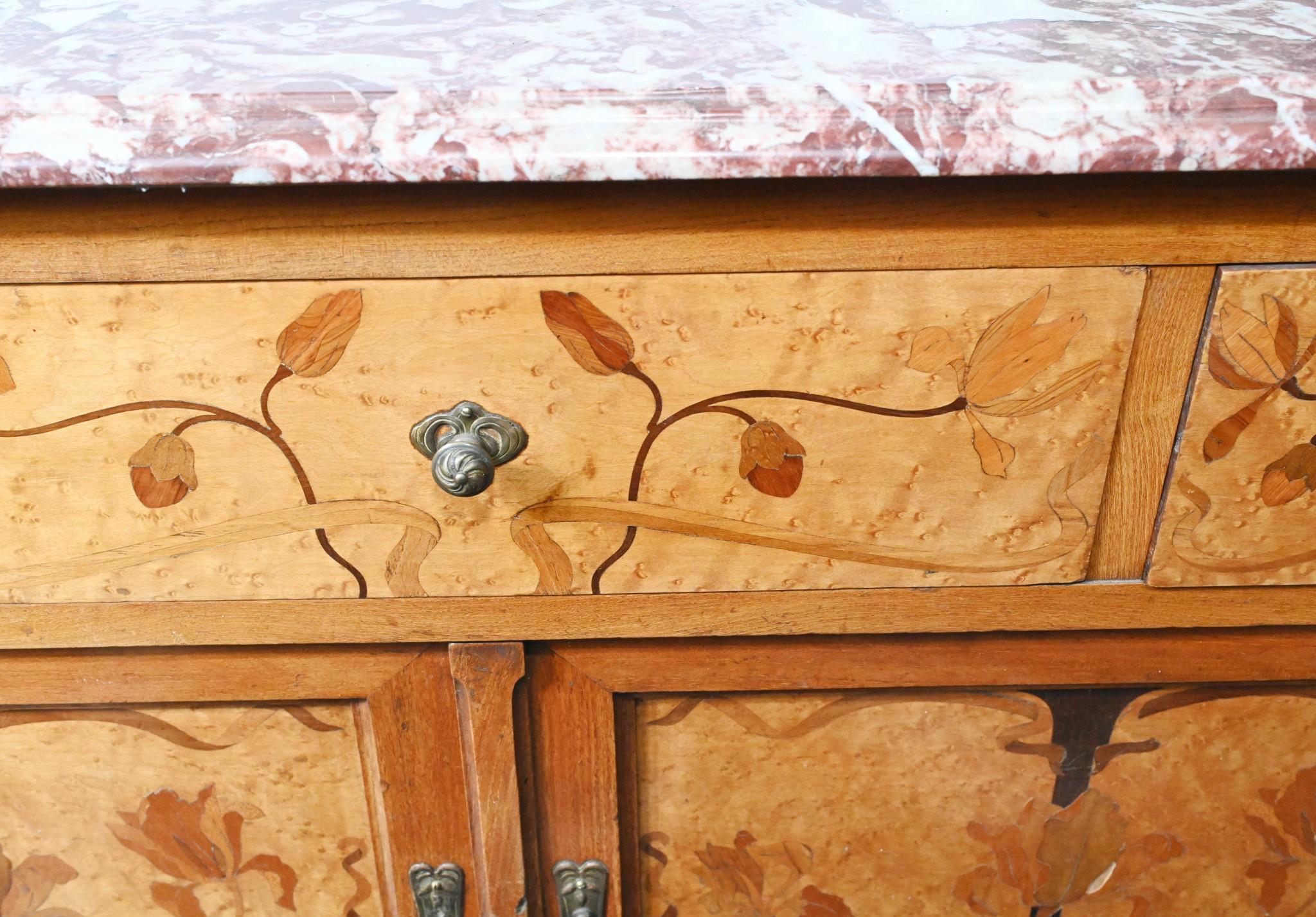 Gorgeous art nouveau commode or cabinet in blonde walnut
Features intricate inlay work showing floral motifs and designs
Comes with the coloured marble top which is smooth and chip free
Great purchase on Rue de Rossiers at Paris antiques