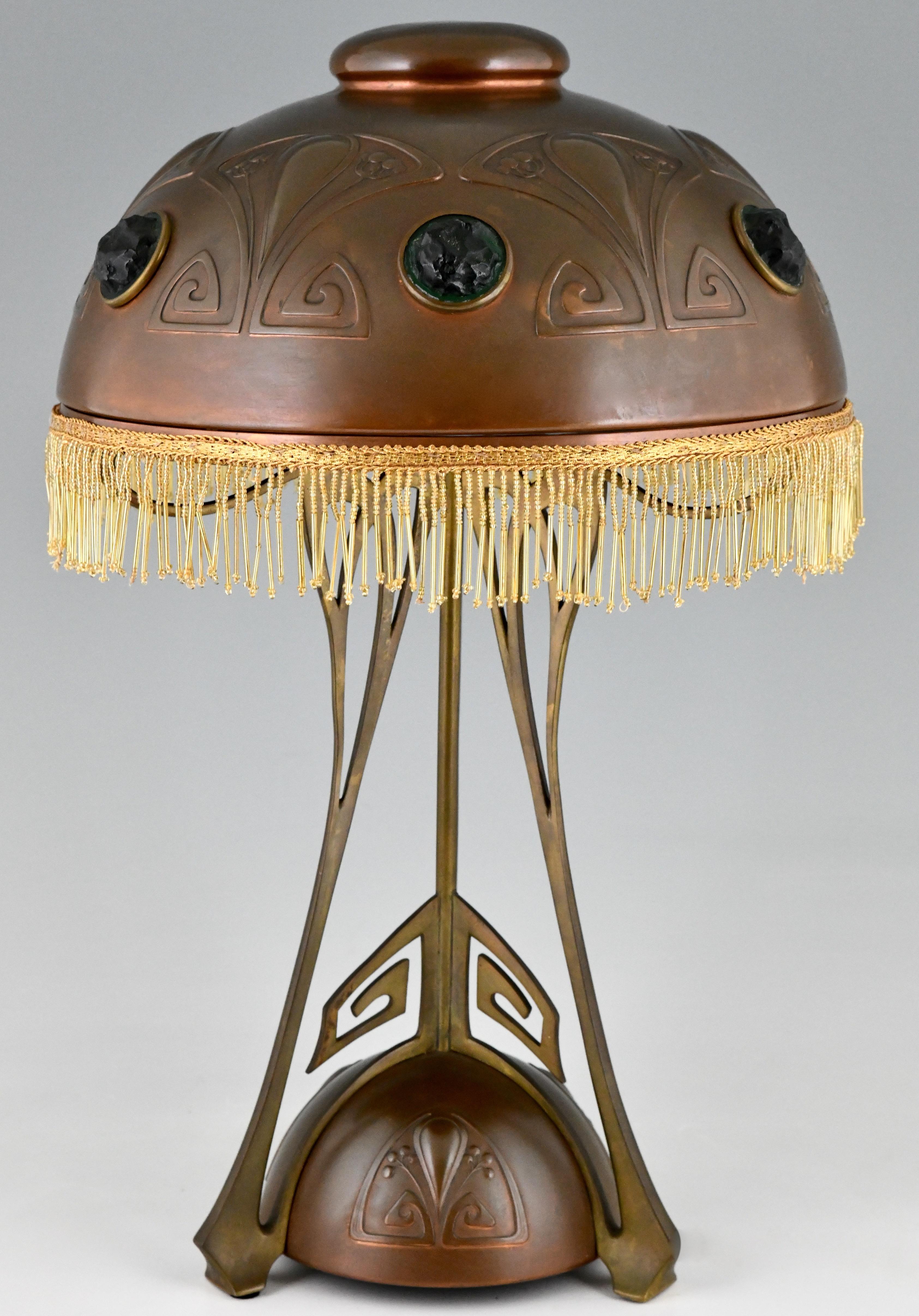 Art Nouveau copper, brass and glass cabochons table lamp with beaded fringe by WMF ca. 1900.
Literature:
”Art nouveau domestic metalwork from Württembergische Metallwaren Fabrik 1906” published by the antique Collectors Club.?“Das