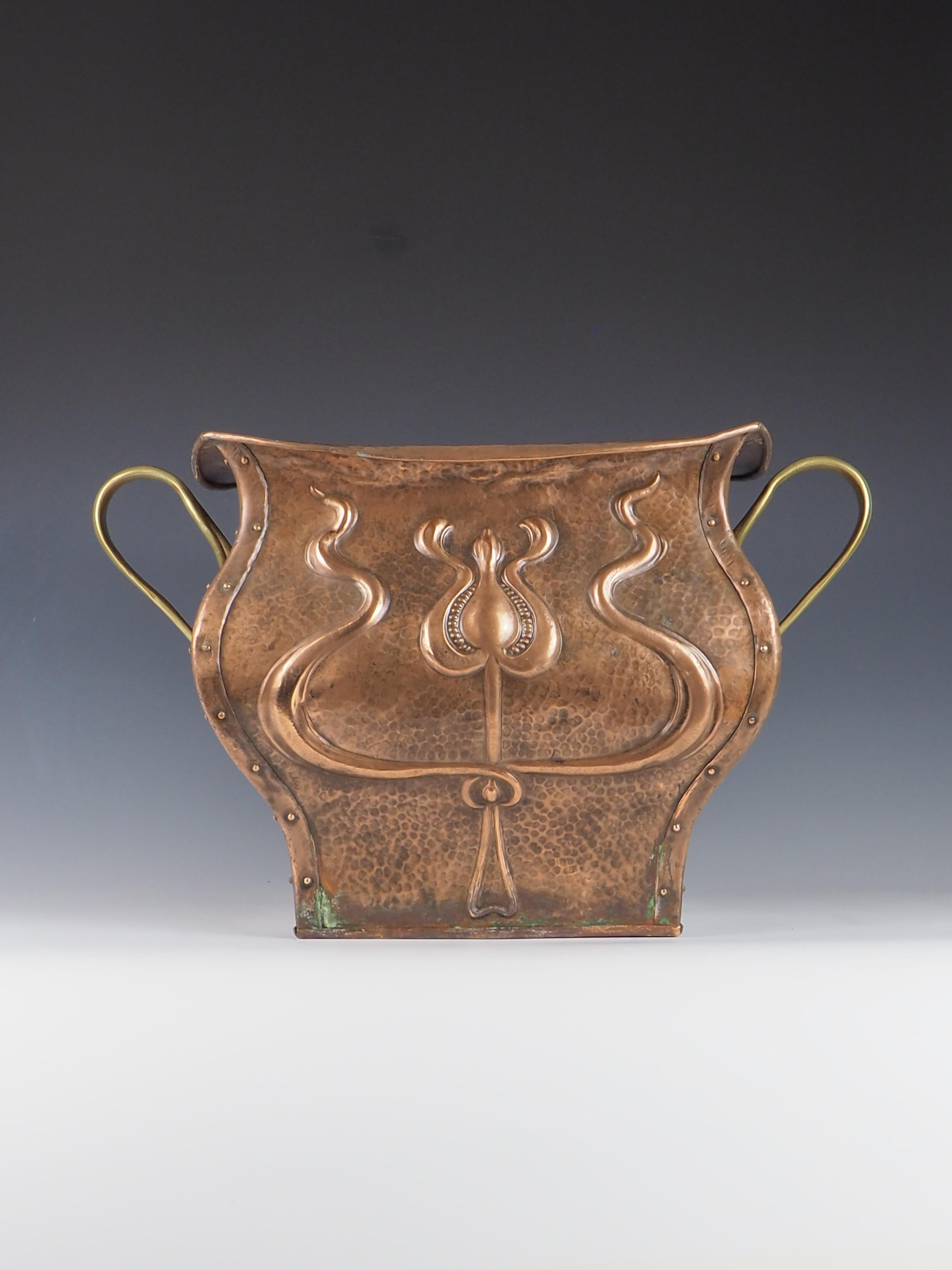 Exquisite Art Nouveau Copper Planter, also could be used as a fireside bucket for kindling, is a striking addition to any home decor.

Crafted from hammered copper, the planter showcases a beautifully intricate Art Nouveau design on two sides,