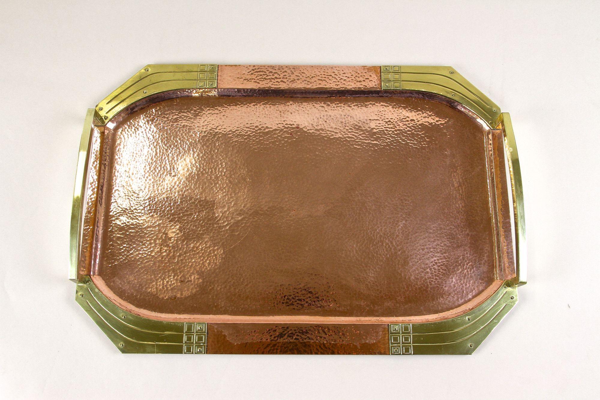 Impressive Art Nouveau copper tray with gilt brass handles from the very early period in Austria. Elaborately handcrafted around 1900, this one of a kind Vienna secession tray is an absolute extraordinary item. A heavy serving tray which has been