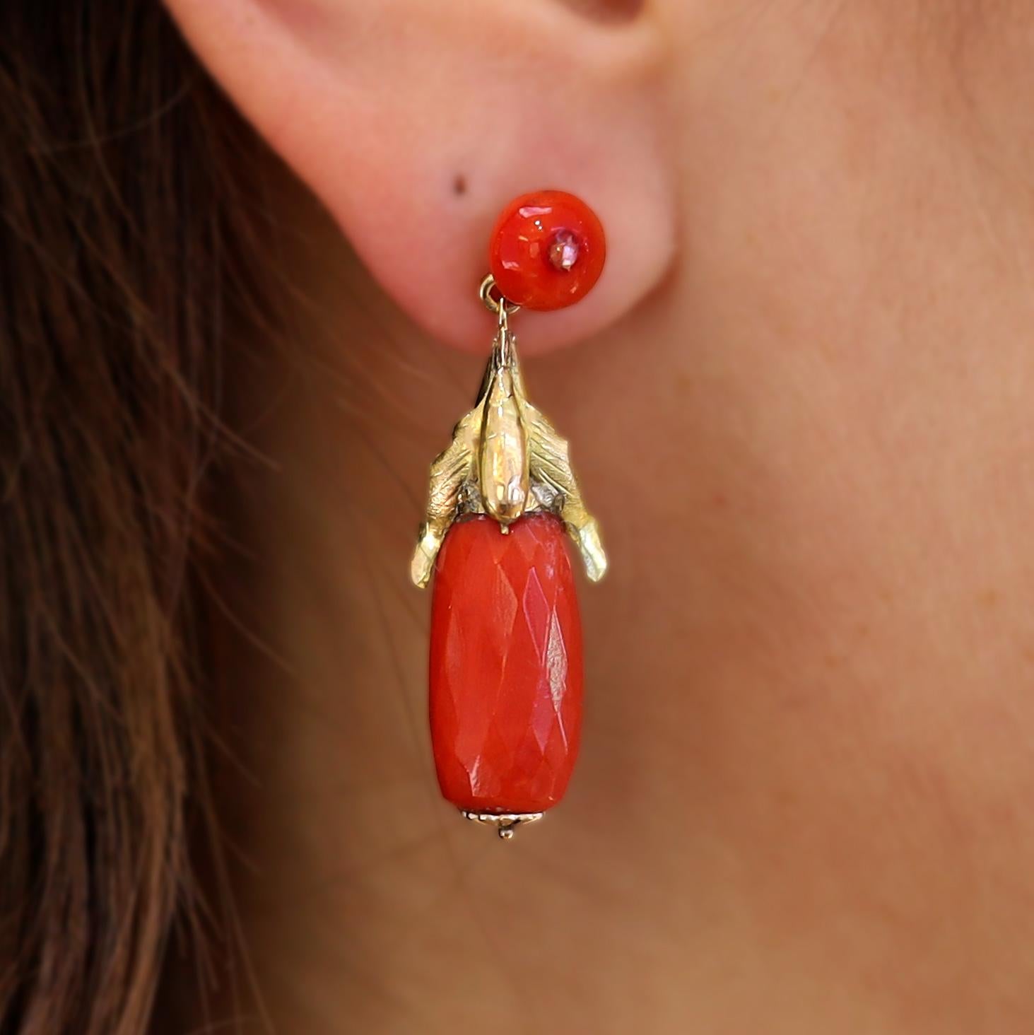 Mysterious and lovely, these authentic Art Nouveau period dangle earrings depict a pair of dozing bats caressing a coral bead. Suspended from the diamond-centered circles of lovely hued Sardinian coral, their wings draped languidly and are rendered