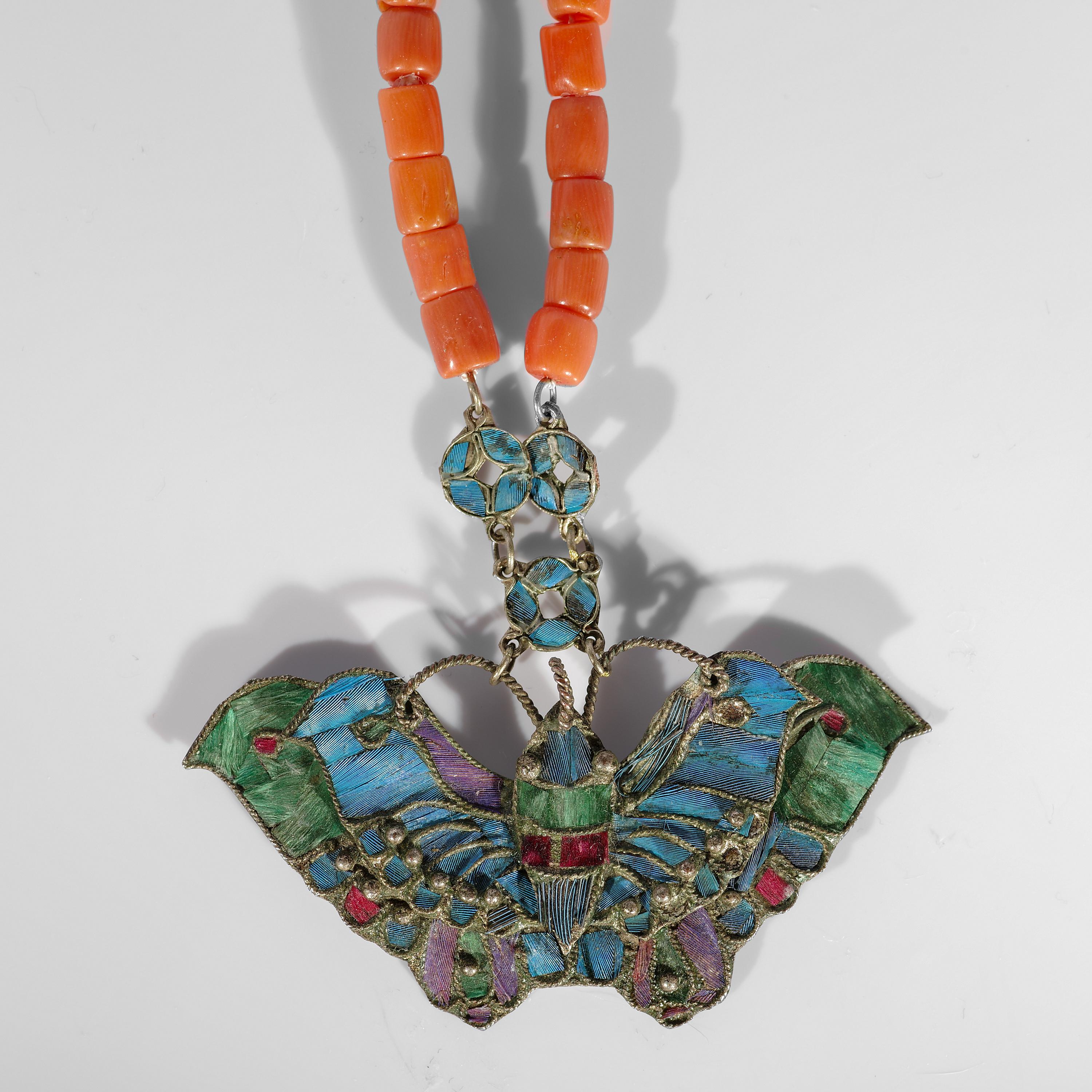 This strikingly unique necklace from the Art Nouveau-era is an elegant and impressive example of the Chinese art form known as tian-tsui. Tian-tsui refers to the decoration of metalwork with the azure, iridescent feathers of the Kingfisher bird. The