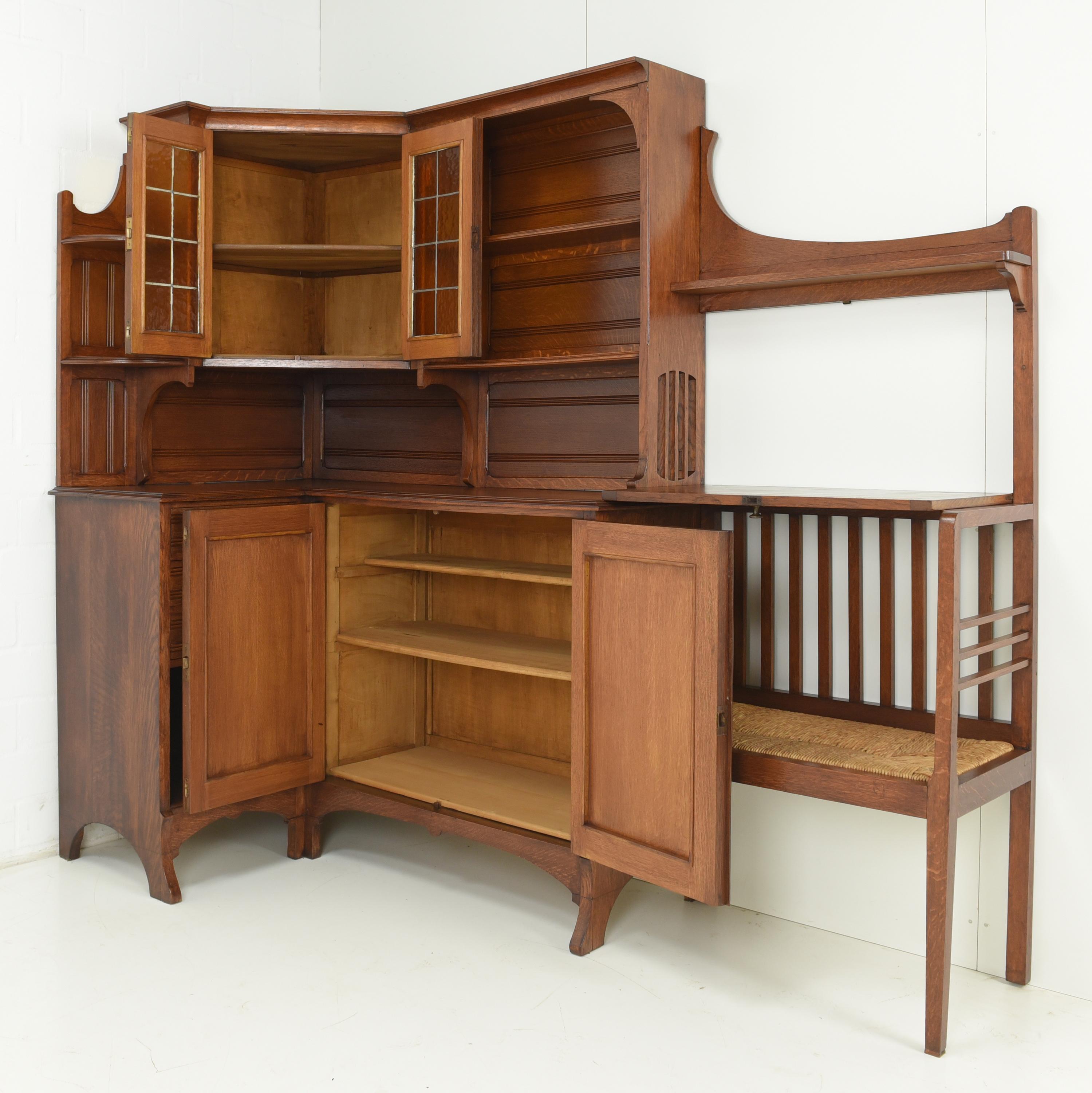 Corner cabinet with bench restored Art Nouveau around 1915 Oak corner furniture

Features:
Asymmetrical corner cabinet with adjoining bench
Interesting division of storage compartments
Organic shaping
High-quality original fittings
Original