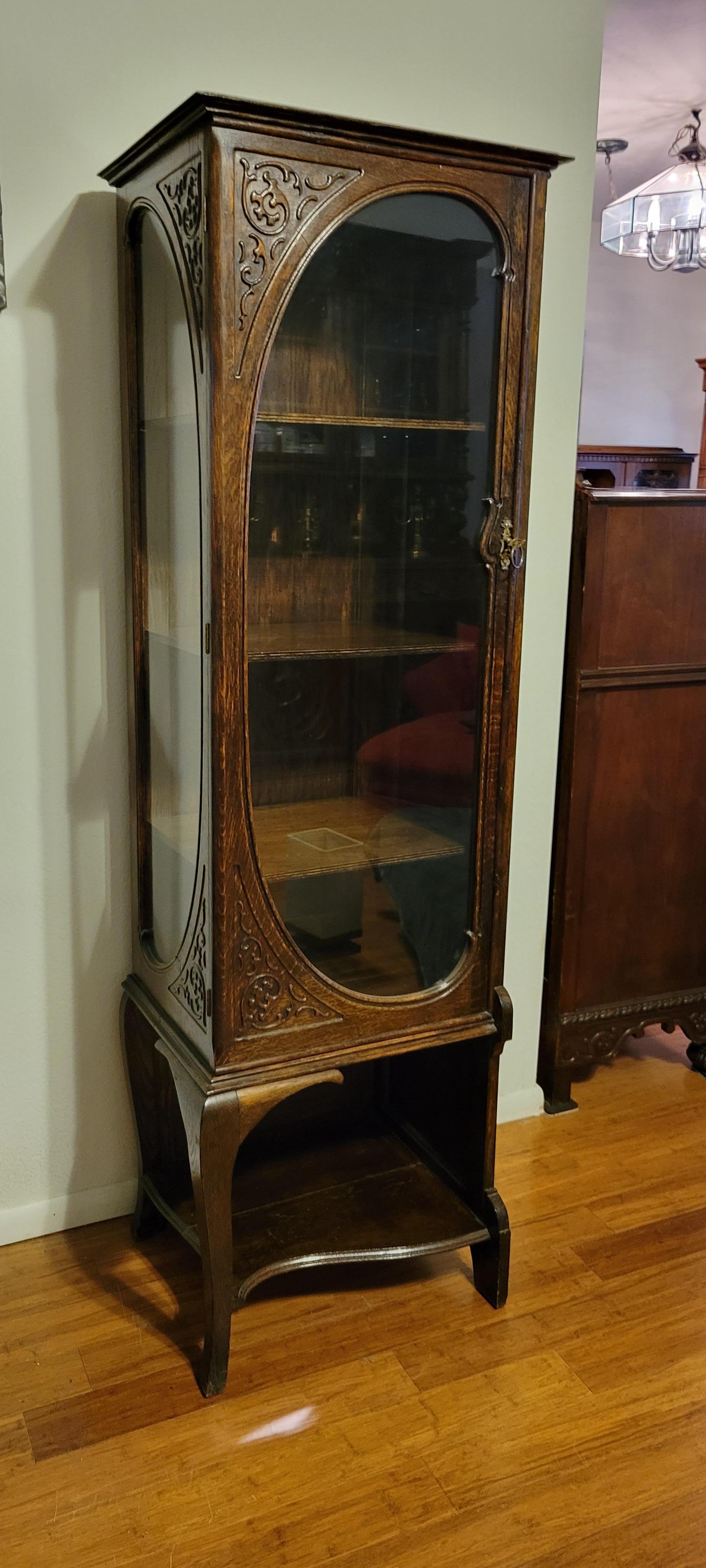 This beautiful Art Nouveau corner Curio was built between 1890 and 1920. It has three shelves and glass in the fron and on the left side. 
The hight of the curio is approximately 66 1/2 inches; it's 18 1/2 inches wide and 15 inches deep. 
The curio