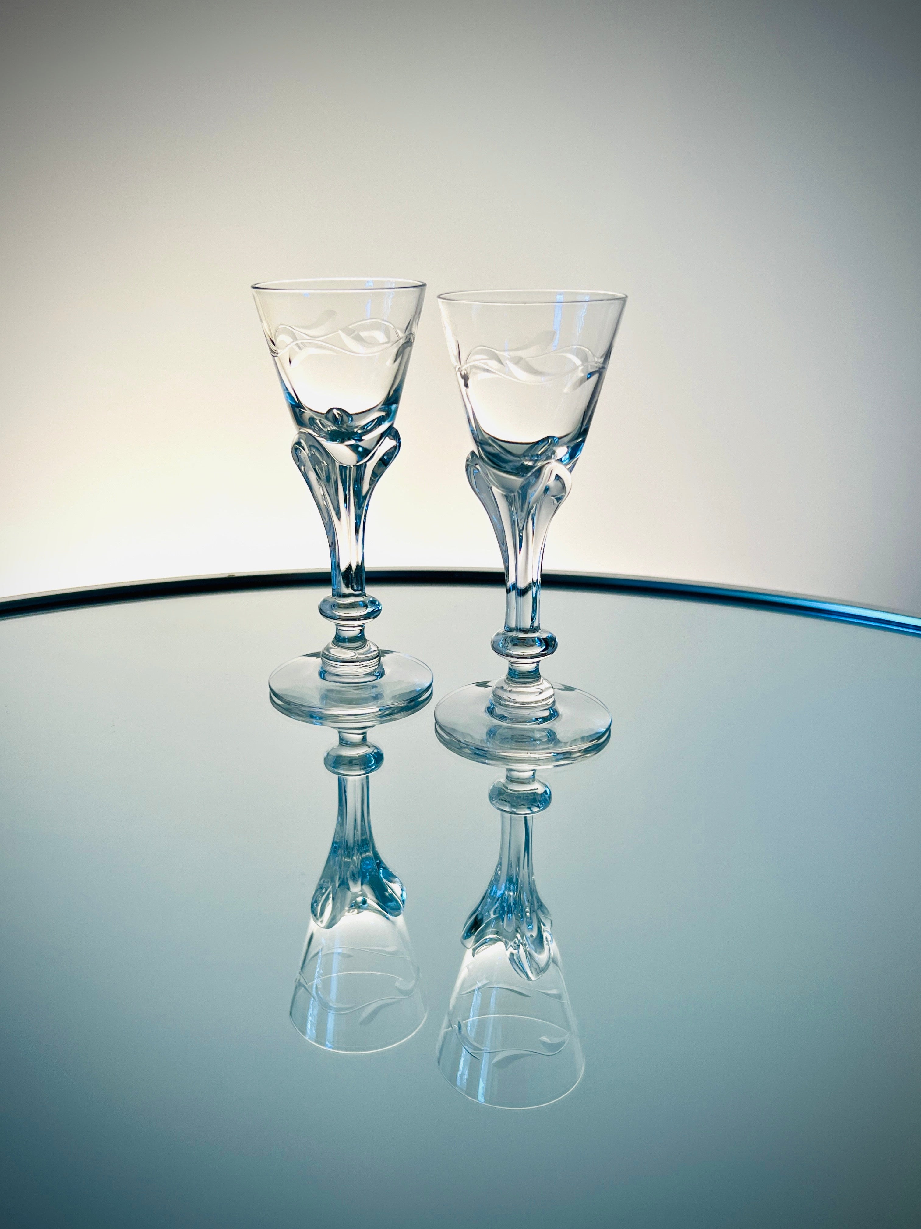 Set / 10 crystal cordial glasses from the Lenox Wreath Collection by Tiffin. The handblown stemware feature an elegant engraved wreath motif and a stylized floral stem, invoking elements of both Art Nouveau and Art Deco designs. The glasses were