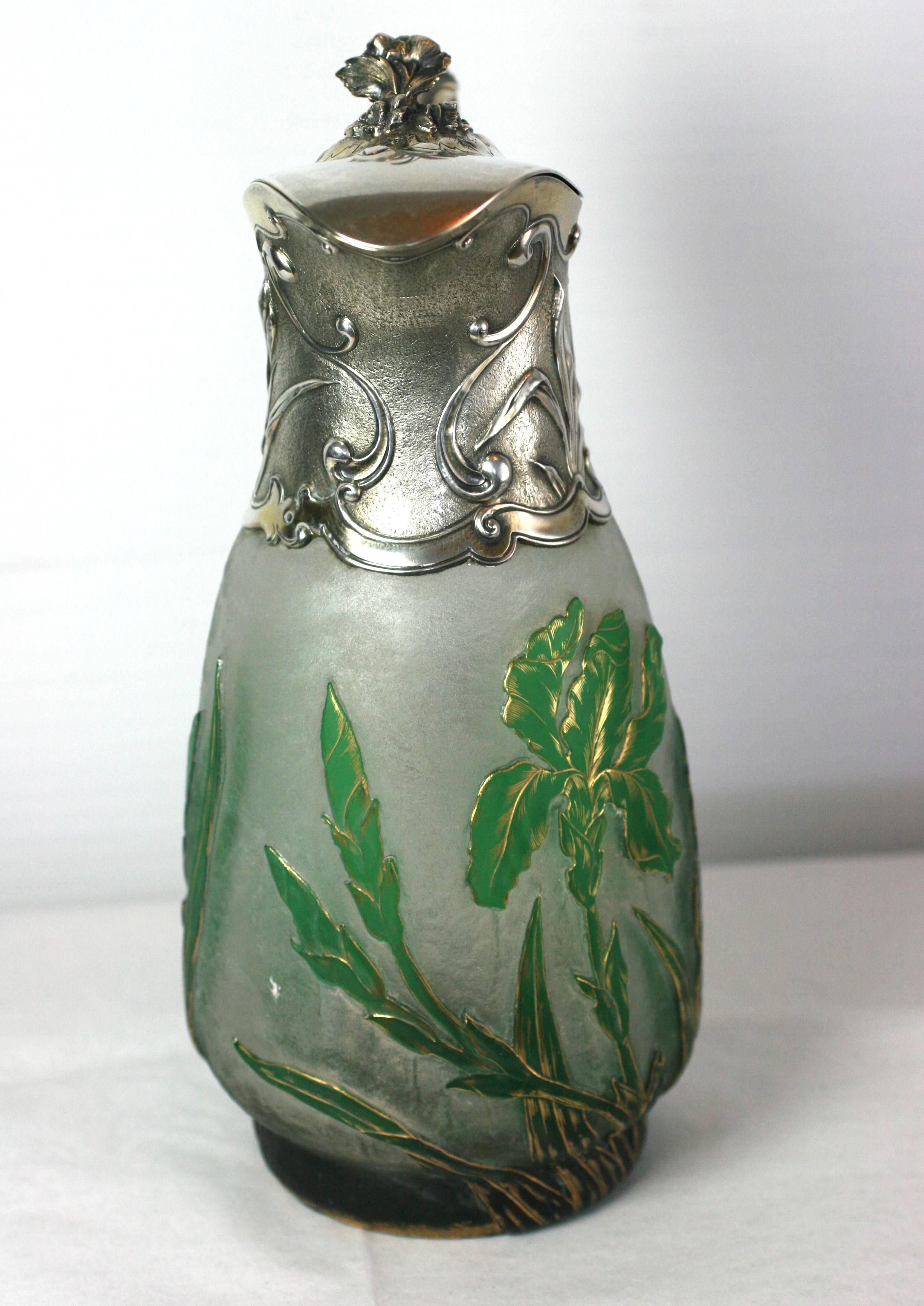 Extraordinary Art Nouveau sterling silver mounted claret jug by Gorham, circa 1900. The glass body, imported from France, is signed Daum, Nancy. It has been tinted emerald green and cameo carved to reveal 3 D flowering irises which are subsequently