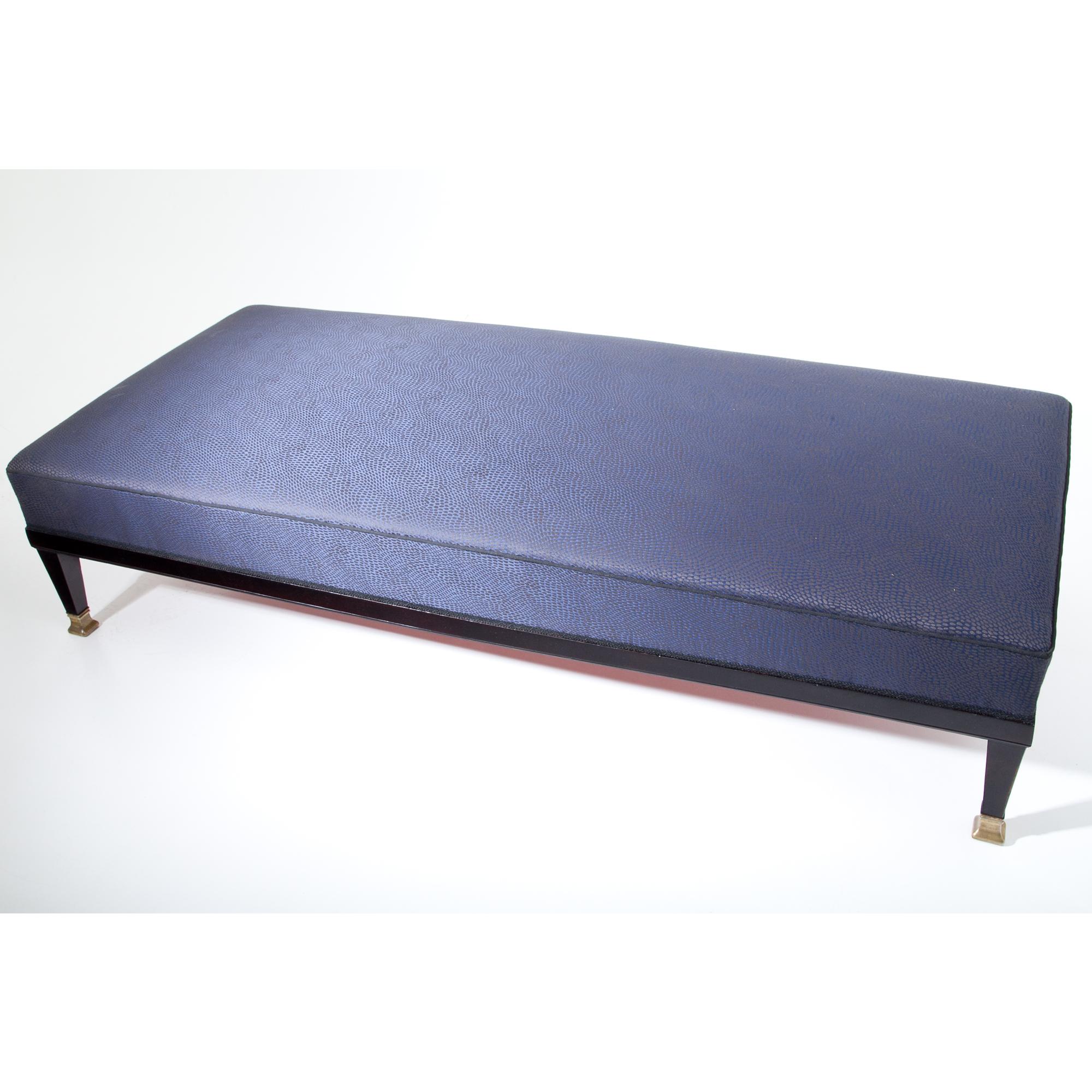 Ebonized Art Nouveau daybed with a straight frame, standing on tapered feet with brass caps. The daybed was hand-polished and reupholstered with a dark-blue patterned fabric.