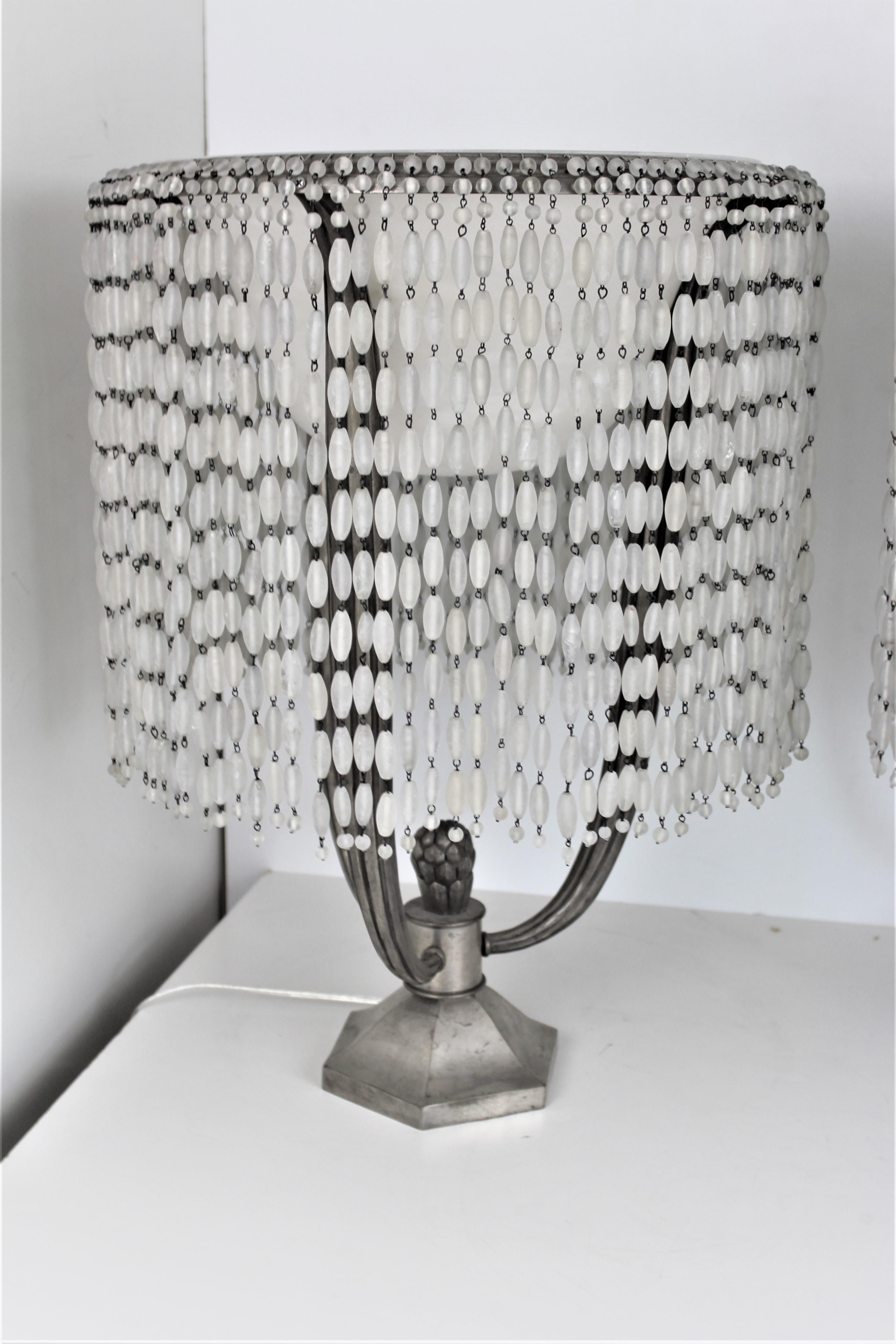 A pair of the Famous designer contemporary cast Lamps with Alabaster inner shade and draped with frosted glass beads. Frame is with three arms sitting on the hexagon base. One of Ruhlmann,s most famous Lamp designs. No others like it around. The