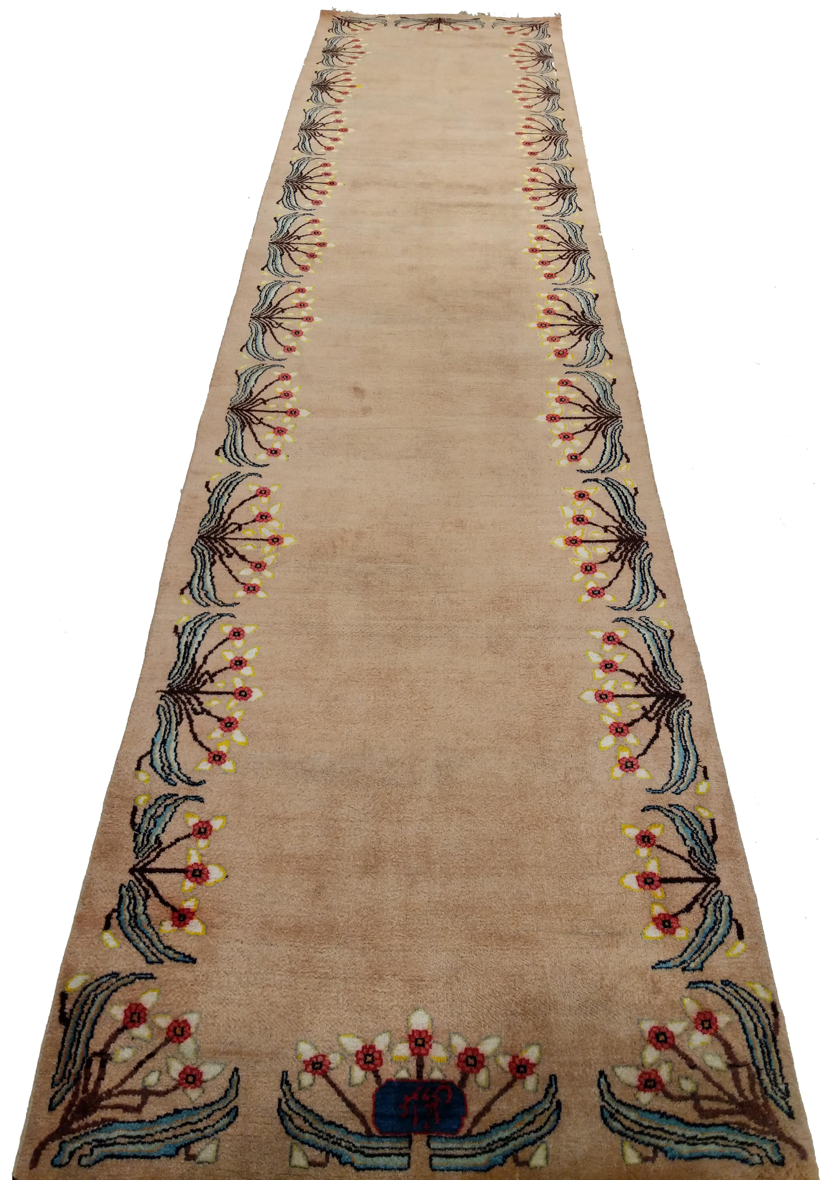 A stunning modernist oriental rug distinguished by a beige open field framed by a floral blossom motif characteristic of Arts & Crafts and Art Nouveau rugs of Europe. Rugs of this type were sometimes commissioned by the architects responsible for