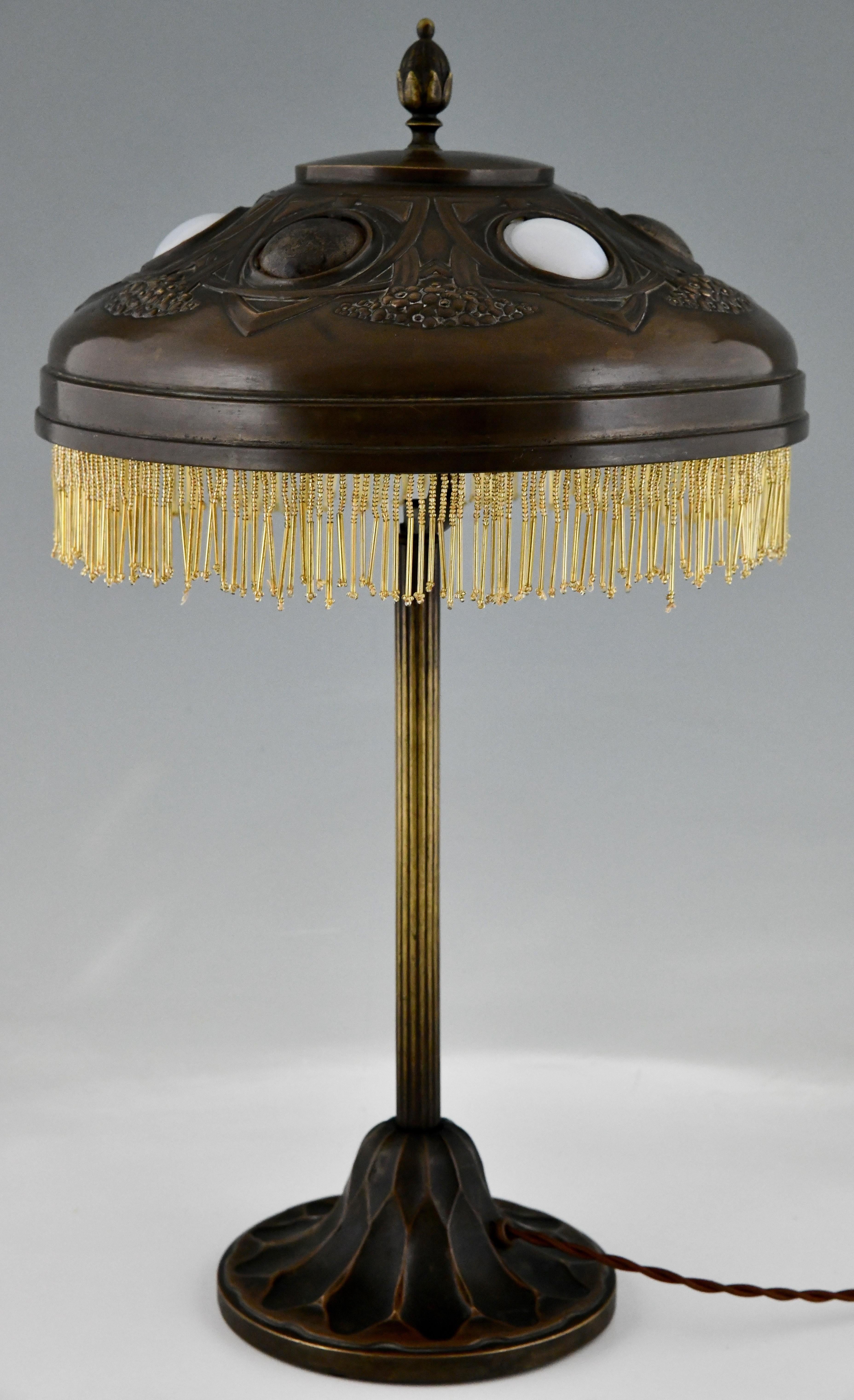 French Art nouveau desk lamp in patinated bronze hammered brass & glas shade 1900 For Sale