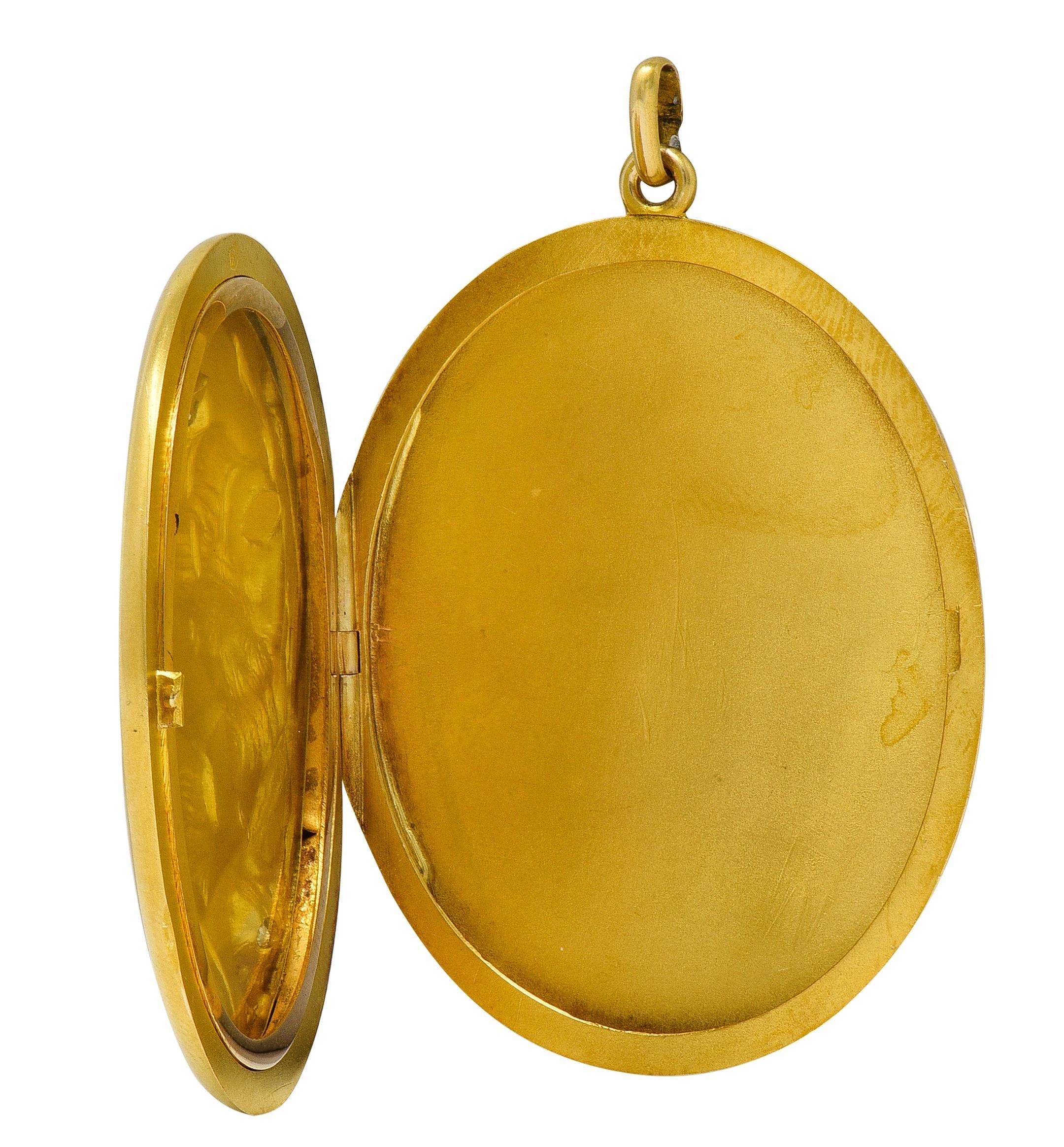 Designed and an oval-shaped locket pendant with chased and repoussé portrait of a woman
Depicted in profile with sweeping hair, tiara, floral bloom, and foliage surround
Accented by bead set old European cut diamonds on flower, tiara, and as