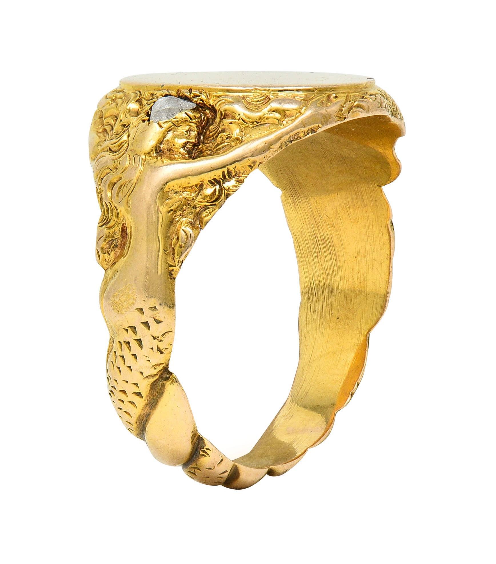 Centering a blank oval-shaped signet face surrounded by mermaid motif surround
Depicted at shoulders with outstretched arms and swirling hair gallery
Shown with rose cut diamonds on heads - quality consistent with cut 
Weighing approximately 0.16