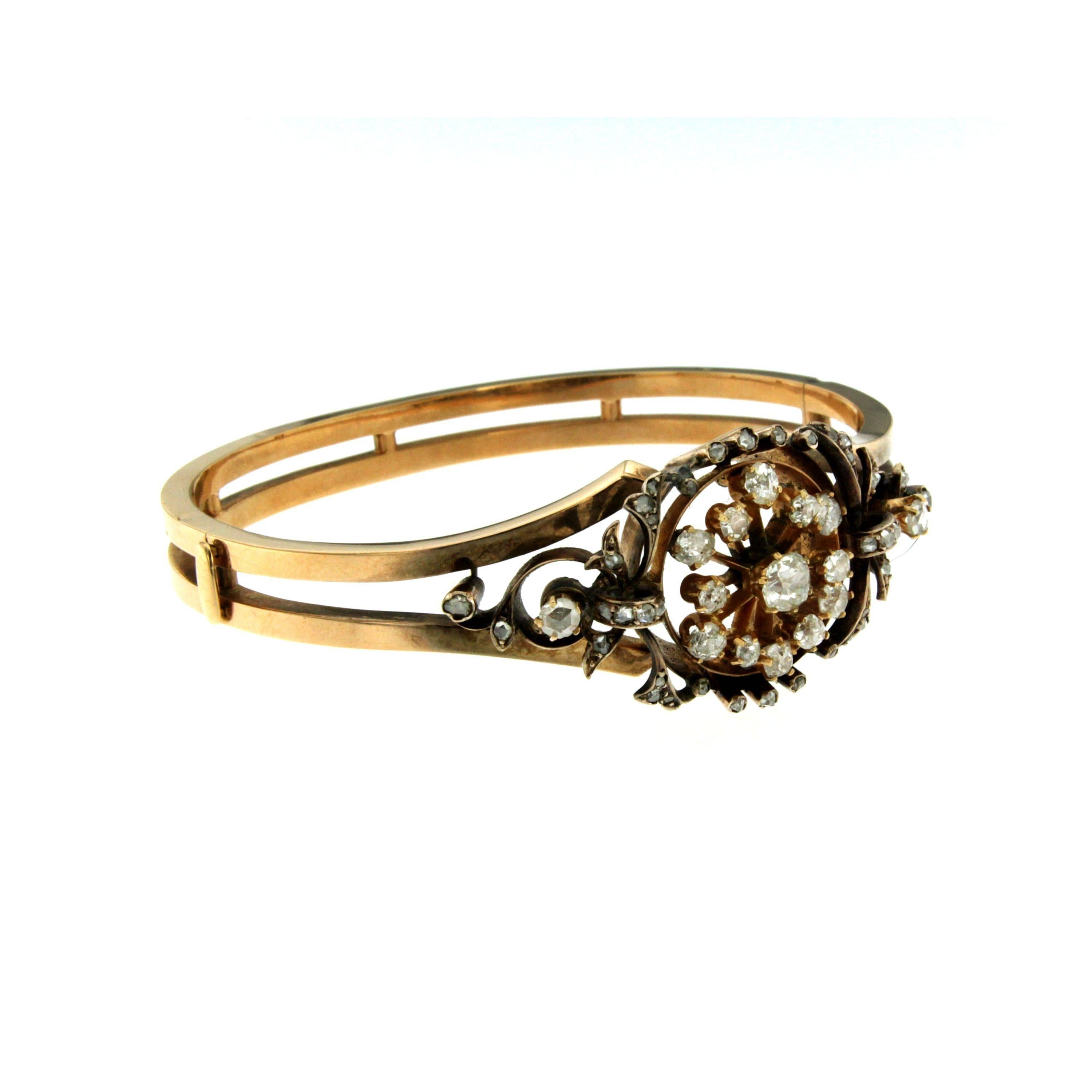 This Art Nouveau bangle bracelet is crafted in 12K rose gold and is adorned with 2 carats of Sparkling Old mine cut diamonds G-H color VS clarity.
Safety clasp. Circa 1910

CONDITION: Pre-Owned - Excellent
METAL: 12k Gold 
GEM STONE: Diamond 2