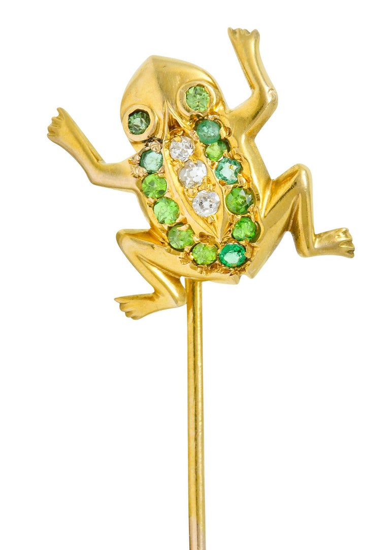 Designed as a cute and stylized frog

Set throughout by round cut demantoid garnets and old European cut diamonds

Tested as 14 karat gold

Circa: 1905

Frog measures: 5/8 x 1/2 inch

Total length: 2 1/2 inches

Total weight: 2.0 grams

Accented.
