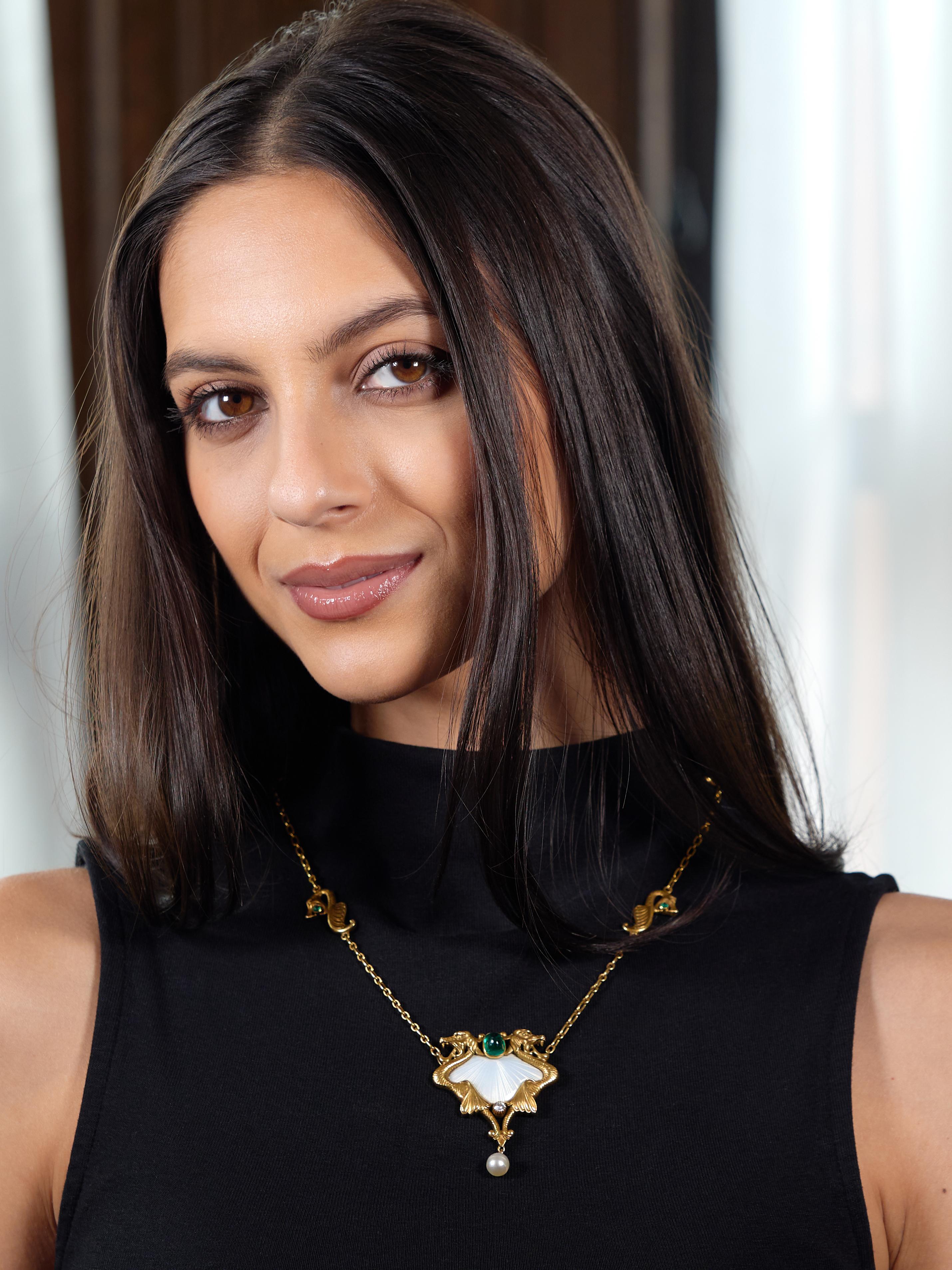 Necklace is comprised of elongated cable link chain with stylized dragon stations
Each station is highly rendered while clutching an emerald cabochon in its mouth
Very well matched bright green in color - weighing approximately 0.25 carat