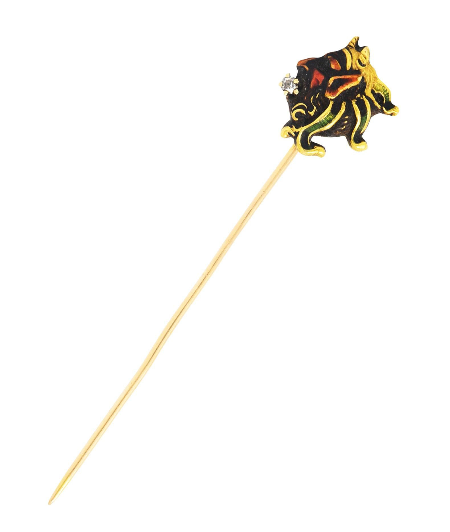 Stickpin designed as profile of the god Pan with curling hair and grooved horns

With orangey red and deep green enamel - quality consistent with age

Accented by prong set diamond in mouth

Eye clean and bright

Stamped 14k for 14 karat