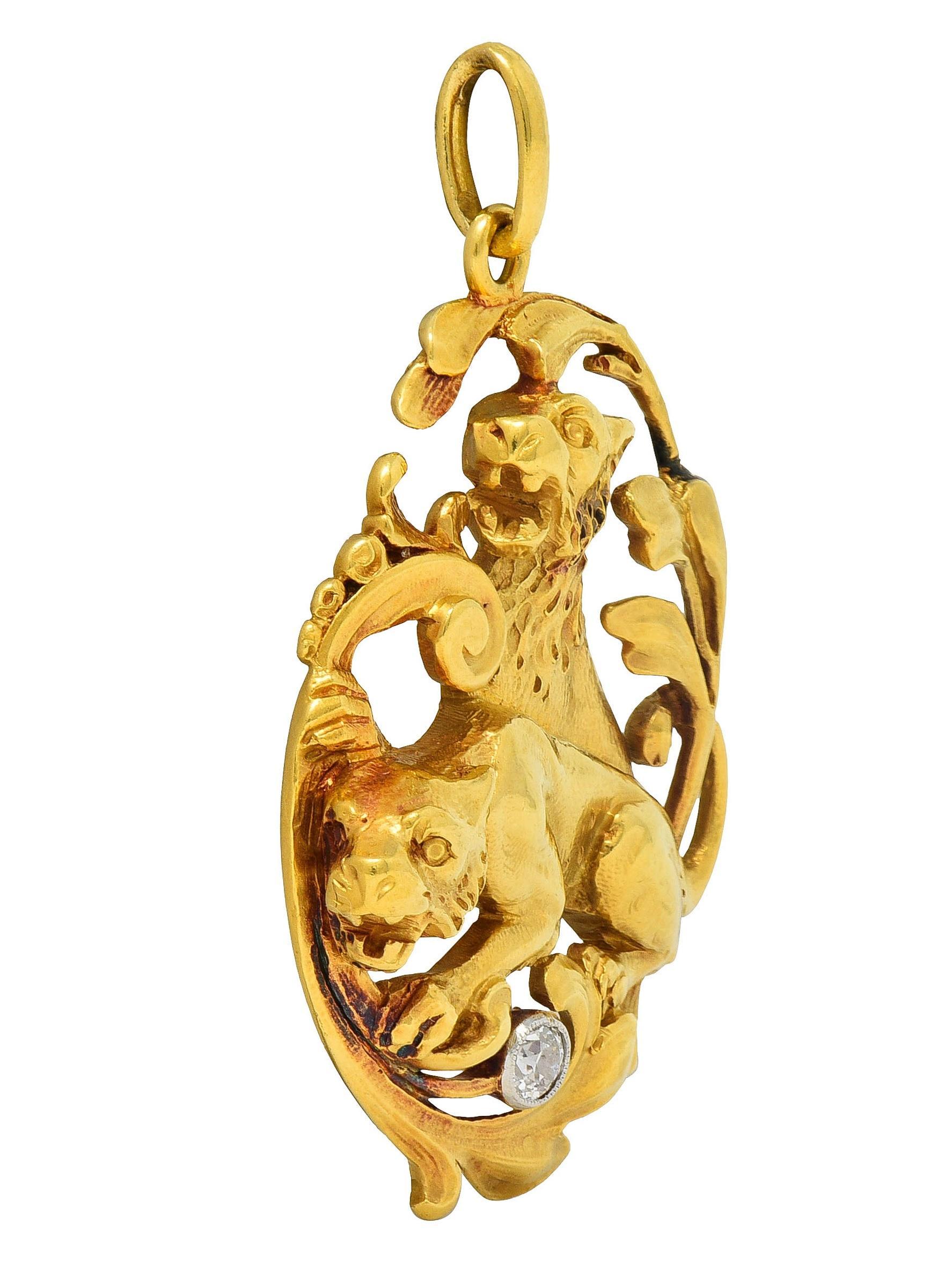 Designed as two dimensional lions amidst scrolling foliate
Depicted sitting and crouched with bared fangs and textured fur
Foliate surround is overlapping with grooved whiplash details
With an old European cut diamond in platinum milgrain