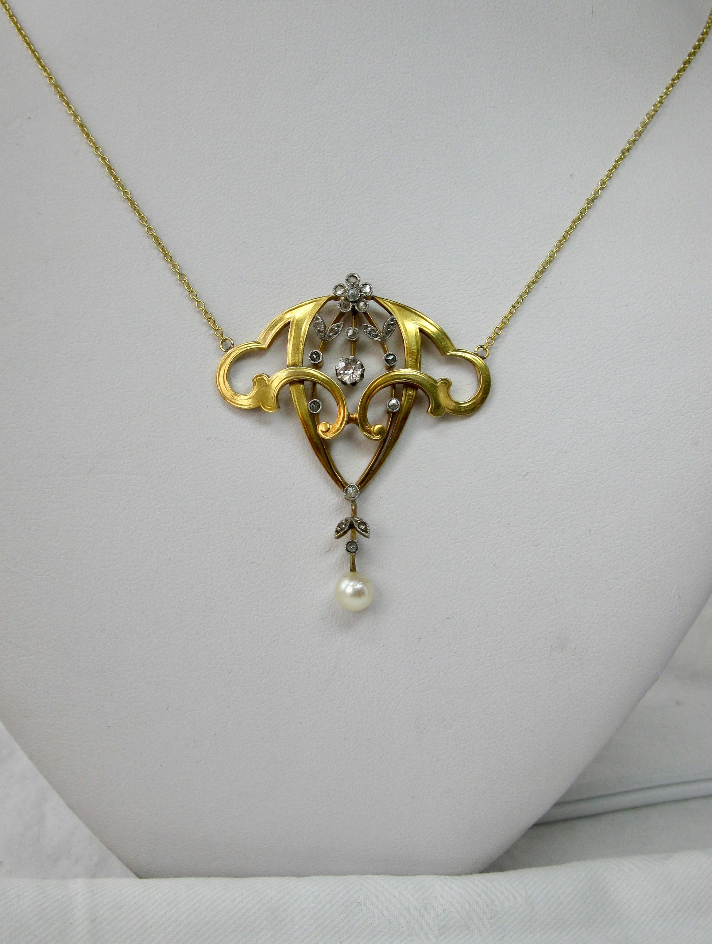 
This is an extraordinary museum quality Art Nouveau, Belle Epoque Pendant Necklace set with Rose Cut and Old Mine Cut Diamonds in Platinum and 18 Karat Gold with a Pearl pendant.  The jewel with a central Old Mine Cut Diamond of .20 Carat.  The