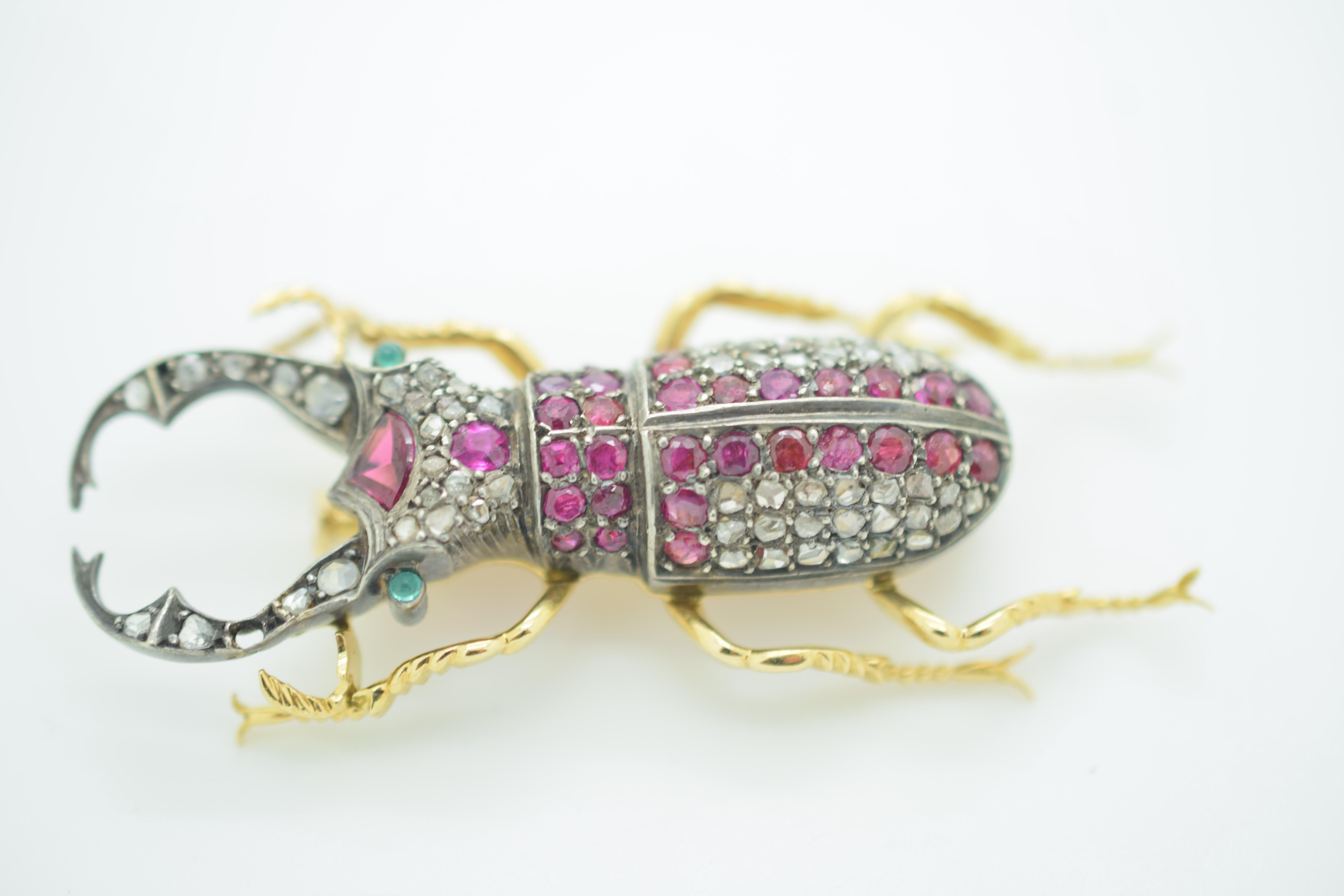 Vintage Ruby and Diamond vintage scarab brooch. This piece is truly exceptional. Details are endless as the gemstones show the true age of this piece. Crafted in 18k yellow gold this piece has detail throughout. The top portion of this brooch is