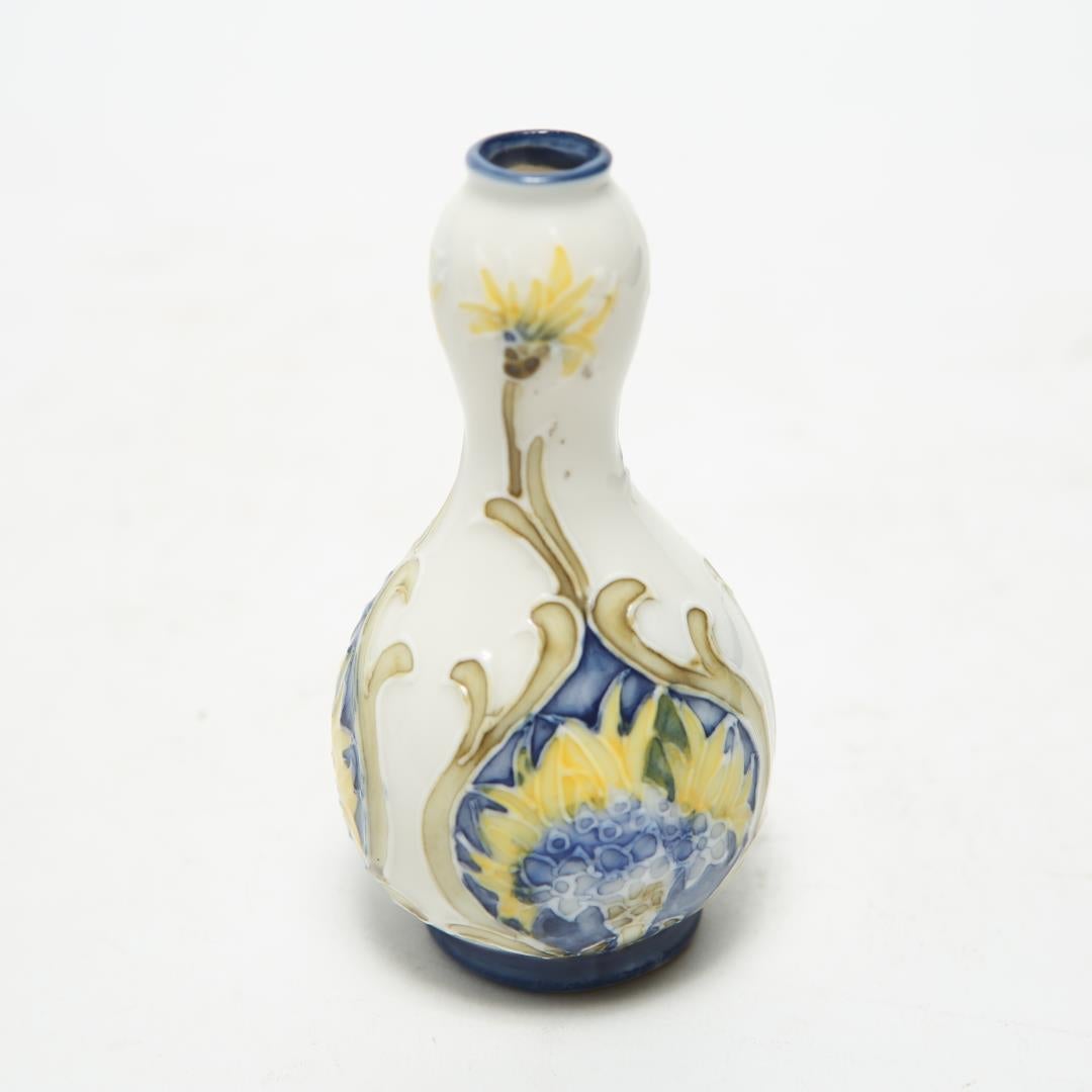 Art Nouveau period diminutive porcelain vase in double-gourd form with yellow and blue painted flowers. The piece is in great vintage condition.