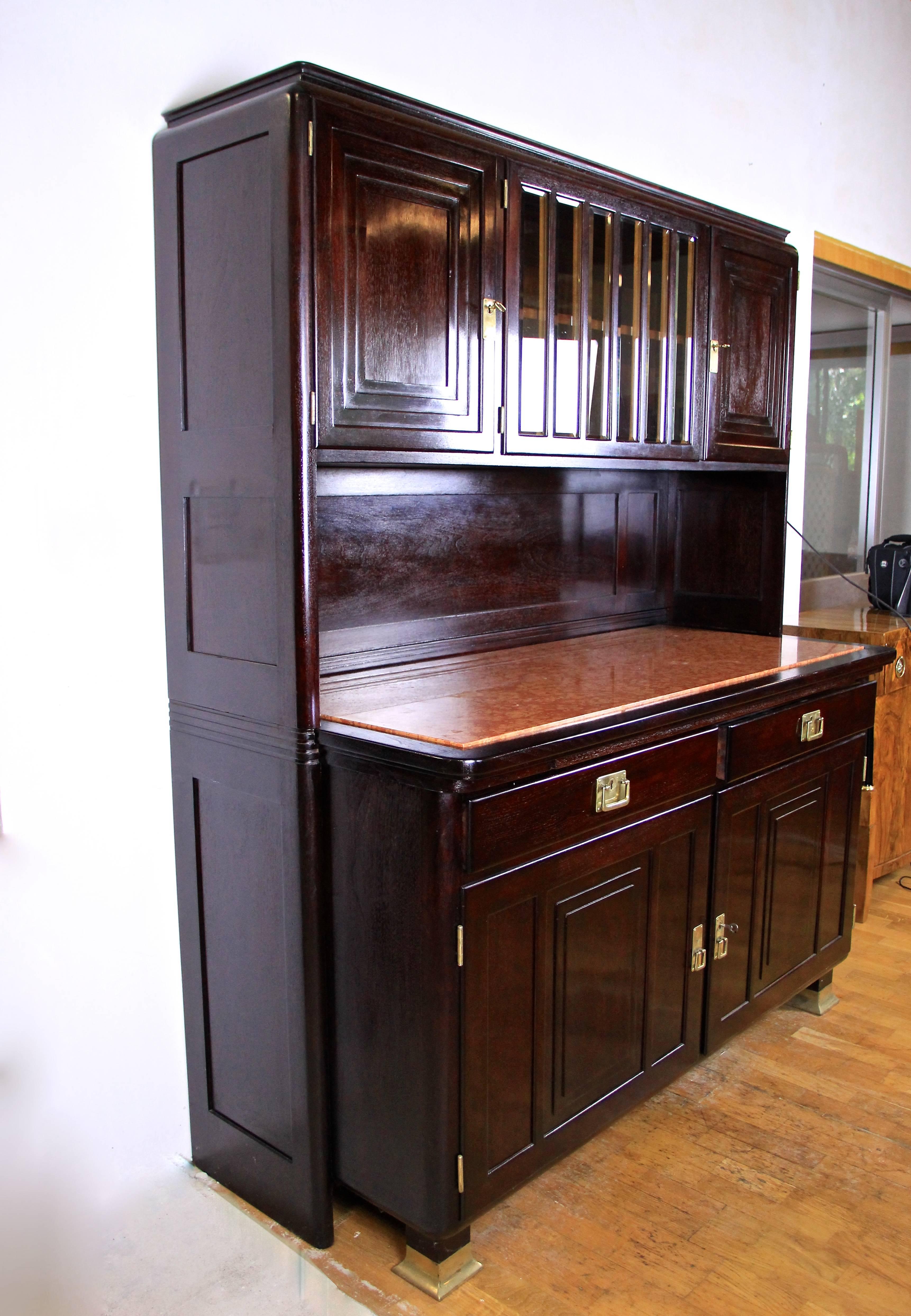 Marvellous Art Nouveau dining room sideboard from Austria, circa 1910. This tall cabinet was designed and produced by August Ungethüm in Vienna. Made of fine mahogany this dining room sideboard or cabinet excels through its unique design. The upper