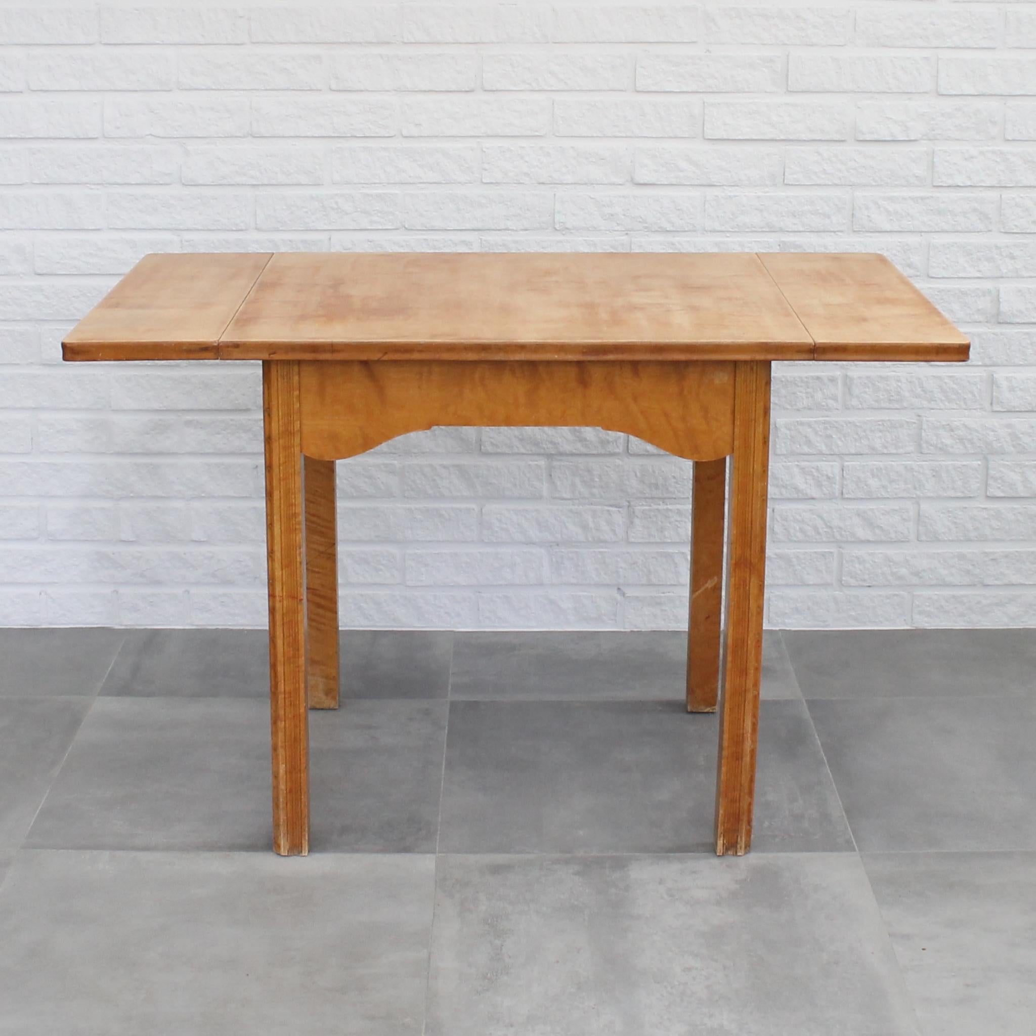 Swedish Art Nouveau dining table constructed from solid birch featuring adjustable sizing with a flap on each side of the table top. Produced in 1912 by Nordiska Kompaniet for the Gasworks of Stockholm and their main offices, which were designed by
