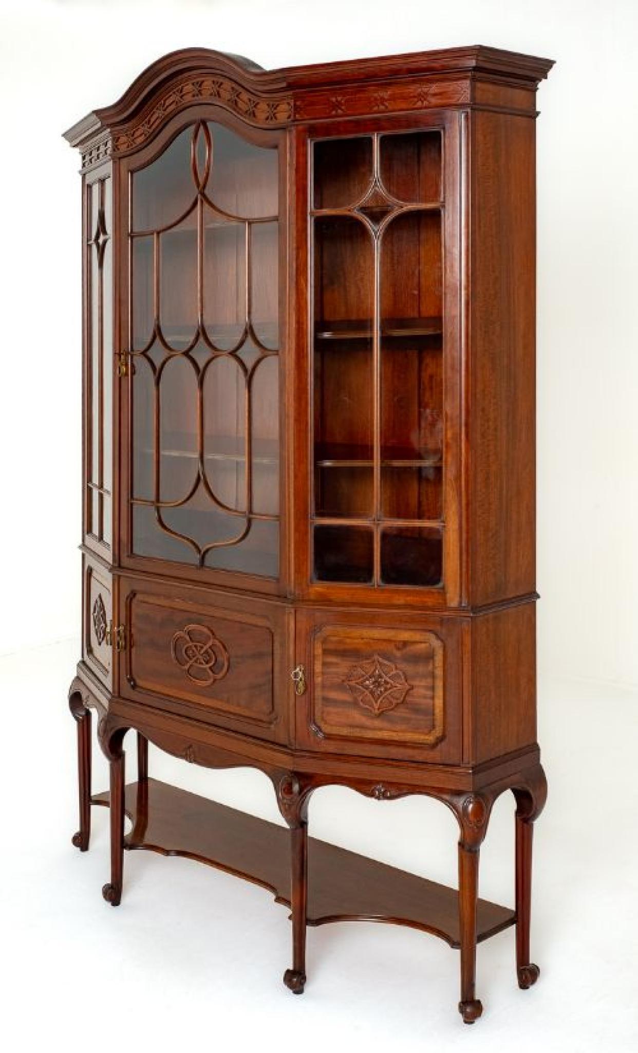 Good quality mahogany Art Nouveau display cabinet.
Circa 1900
This display cabinet stands upon shaped and carved legs with an undertray.
The lower paneled doors featuring blind fret work.
The upper glazed section having a central door which opens to
