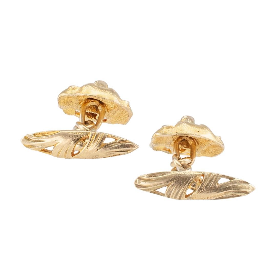 Art Nouveau dog’s head diamond and gold cufflinks circa 1900.  Designed as a pair of dog faces in frontal position, each gripping a diamond in its mouth, the two diamonds totaling approximately 0.10 carat, approximately H color and VS clarity, with