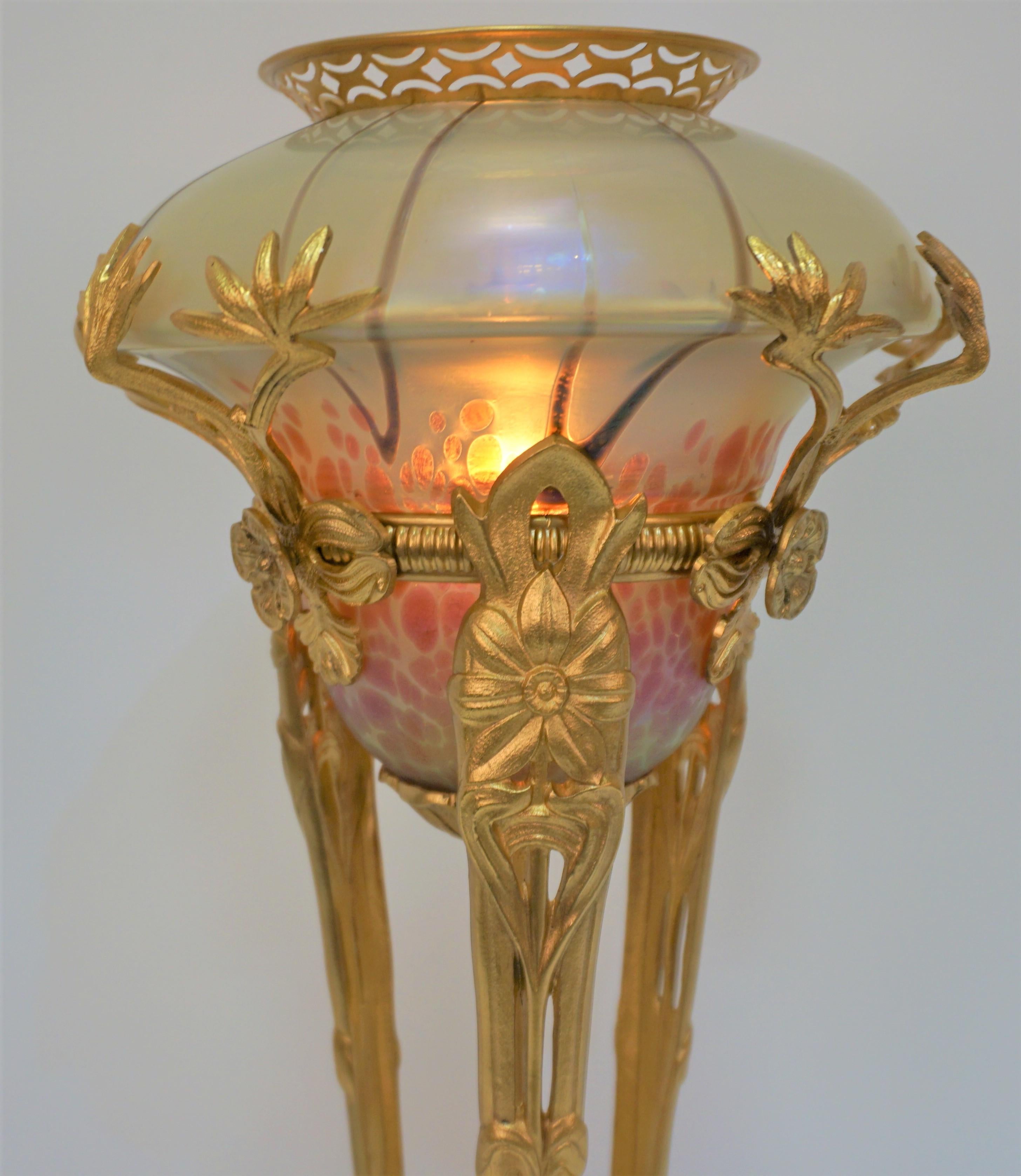 A rare c. 1900 Art Nouveau Dore bronze table lamp with center art glass shade.