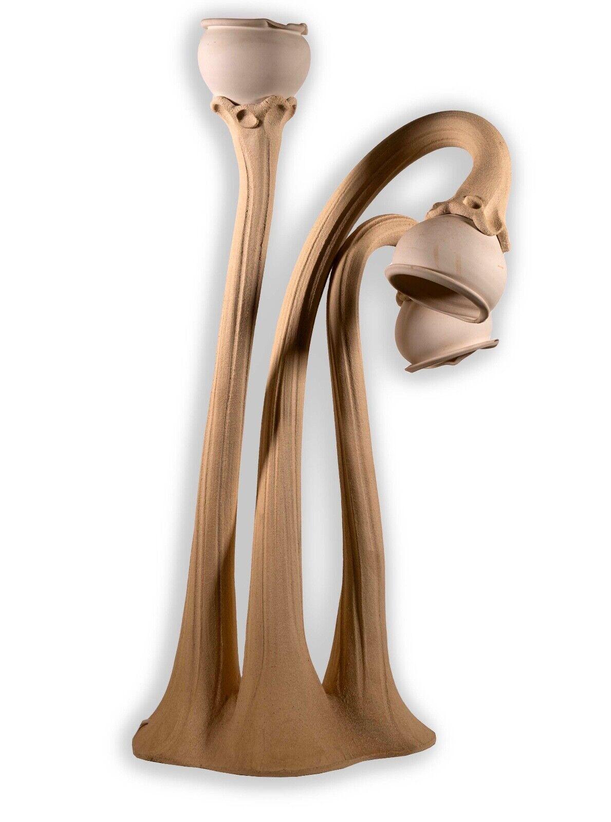 This Art Nouveau-inspired ceramic pottery table lamp by Doug Blum is a stunning fusion of form and function, featuring a captivating design of calla lilies in the Art Nouveau tradition. The lamp is not only a functional lighting piece but also a