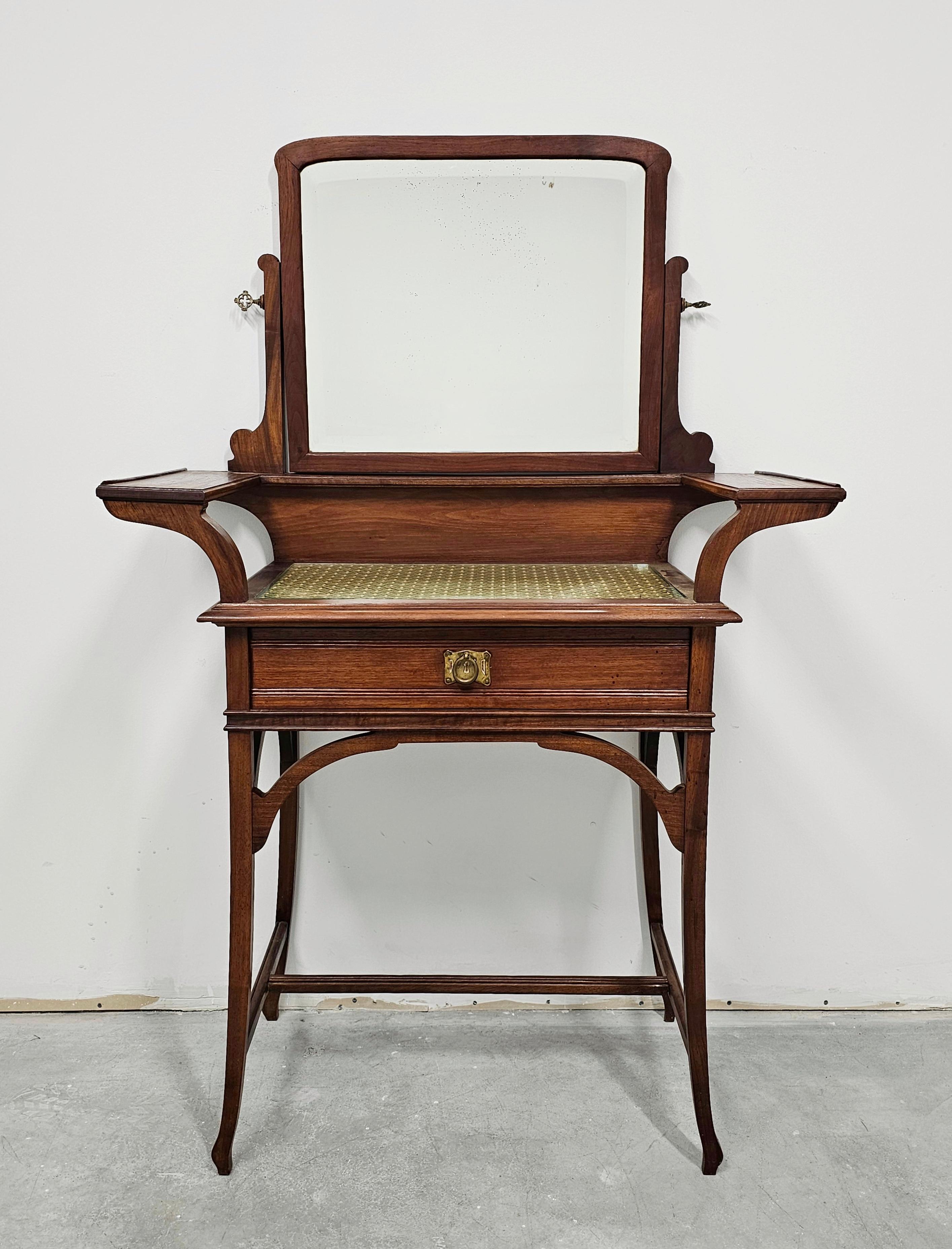 In this listing you will find a very rare Art Nouveau Dressing or Vanity Table with a mirror, done in style of Louis Majorelle. It features beautiful lines characteristic for Art Nouveau style. The table has a single drawer with the original brass