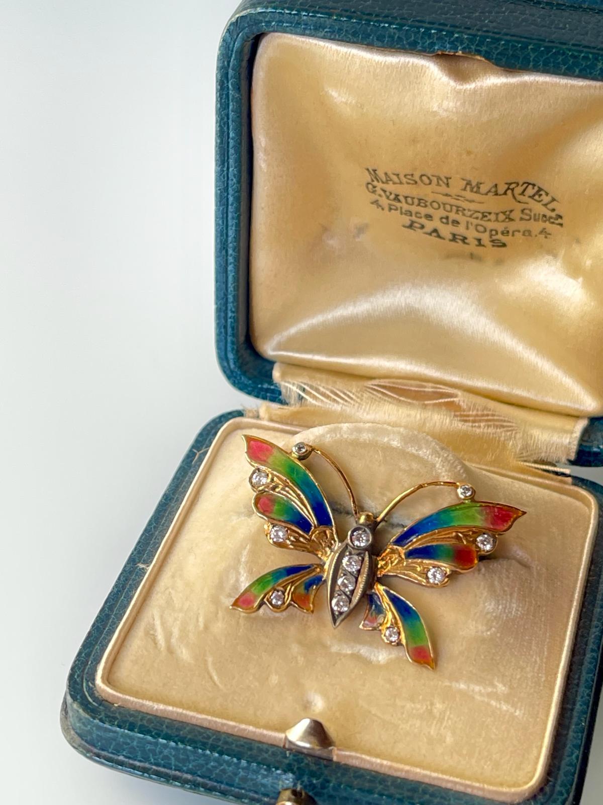 A pretty early 20th C Art Nouveau Edwardian butterfly brooch in 18K yellow gold and silver with rare to find  plique a jour multicolour enamel. 

The brooch is embellished with 12 brilliant cut diamonds at approx. 0.40 ct TW, measures 2.2 x 3.6 cm