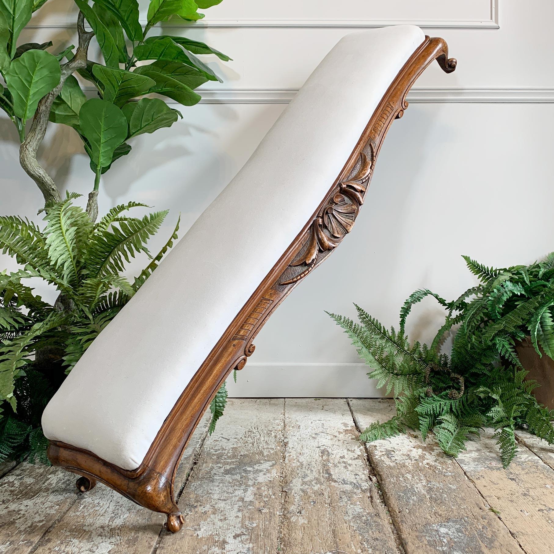 A wonderfully proportioned and very long fireside fender footstool of the art nouveau period, dating to the later end of the 1890’s, the serpentine base with deeply carved art nouveau decoration, sits upon cabriole legs and scroll feet.

The