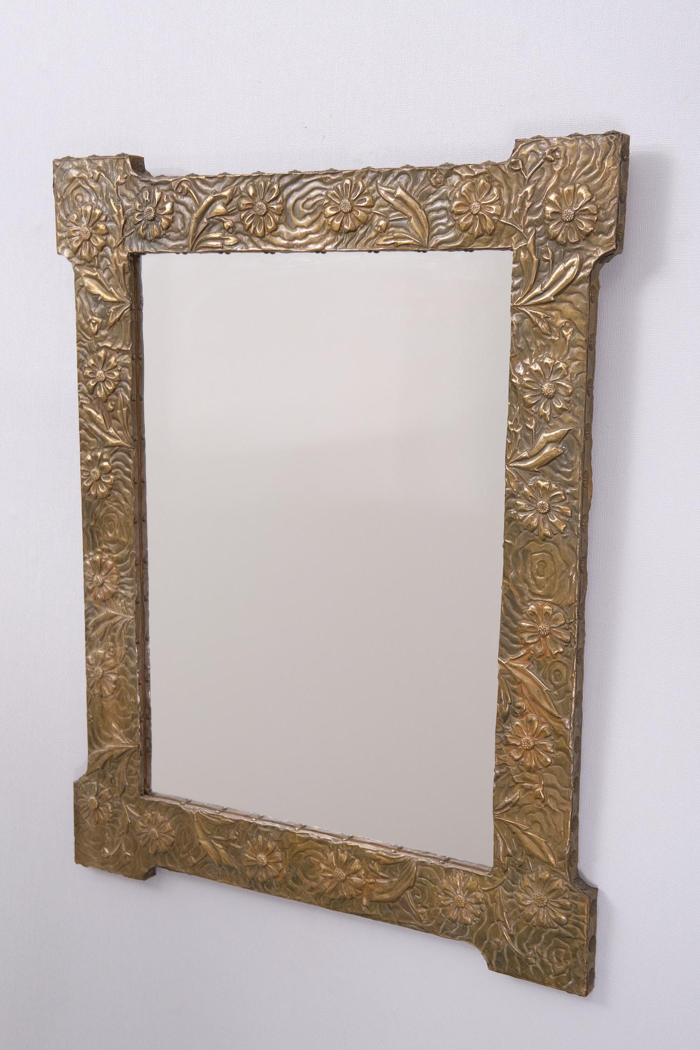 Beautiful Art Nouveau rectangular  Embossed Brass wall Mirror .                      
Decorated with Flowers and leafs . 1920s 
