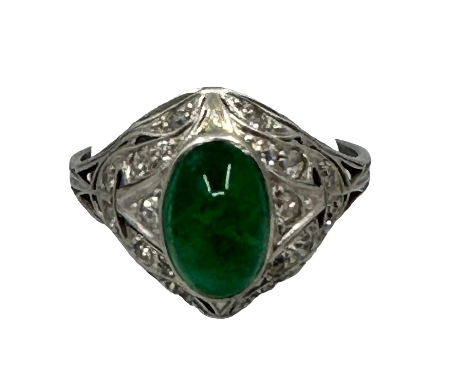 Truly Exquisite Art Nouveau Emerald and and European Cut Diamond Cabochon Platinum Ring.
A beautiful platinum ring that was made circa 1920-1930. It has been set with a large cabochon emerald of Columbian origin. It is a stunning deep green (3.25