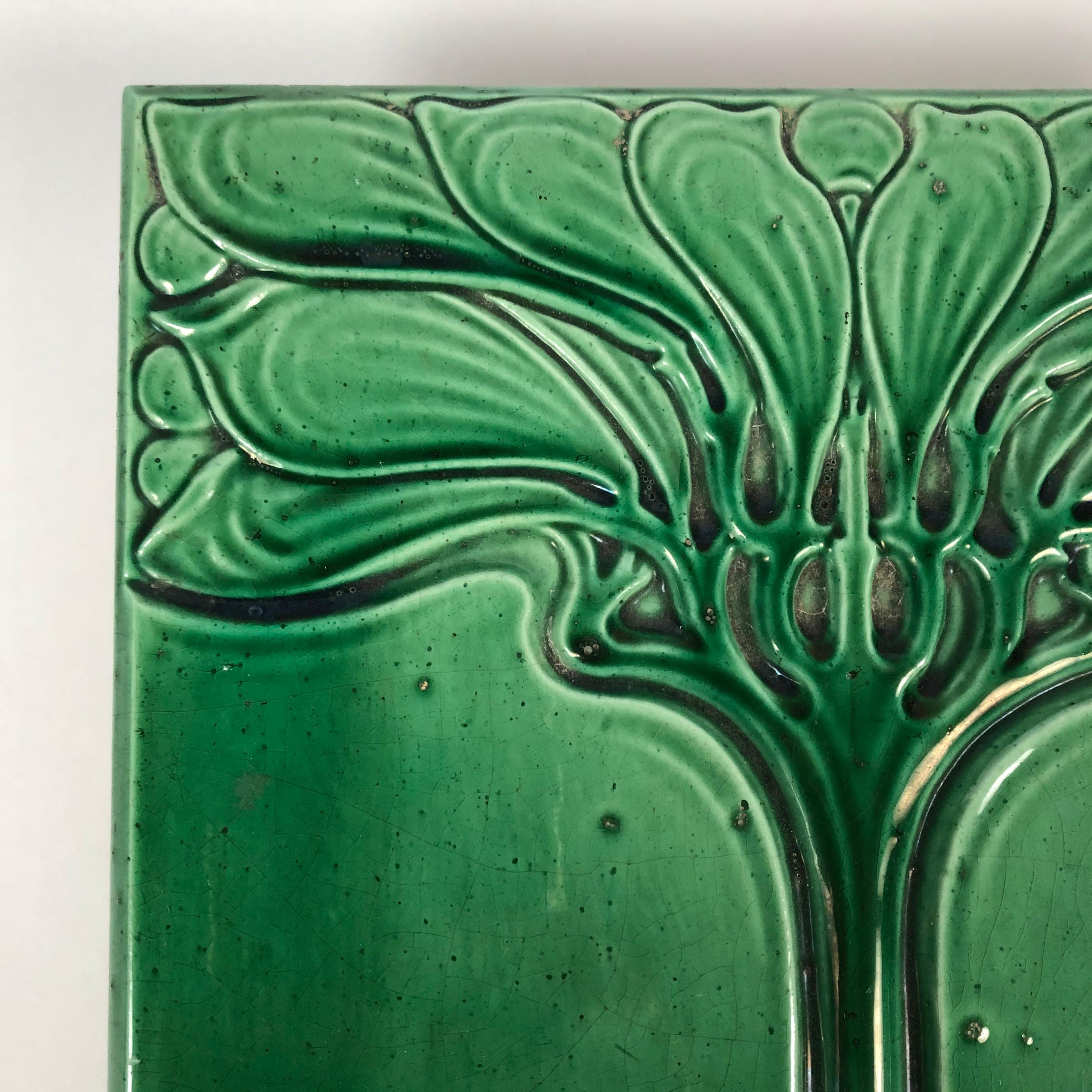 A beautiful Art Nouveau period emerald green glazed ceramic tile decorated with a wonderfully graphic, sinuous, stylized tree.
This tile was originally used in an architectural setting or for a ceramic stove.