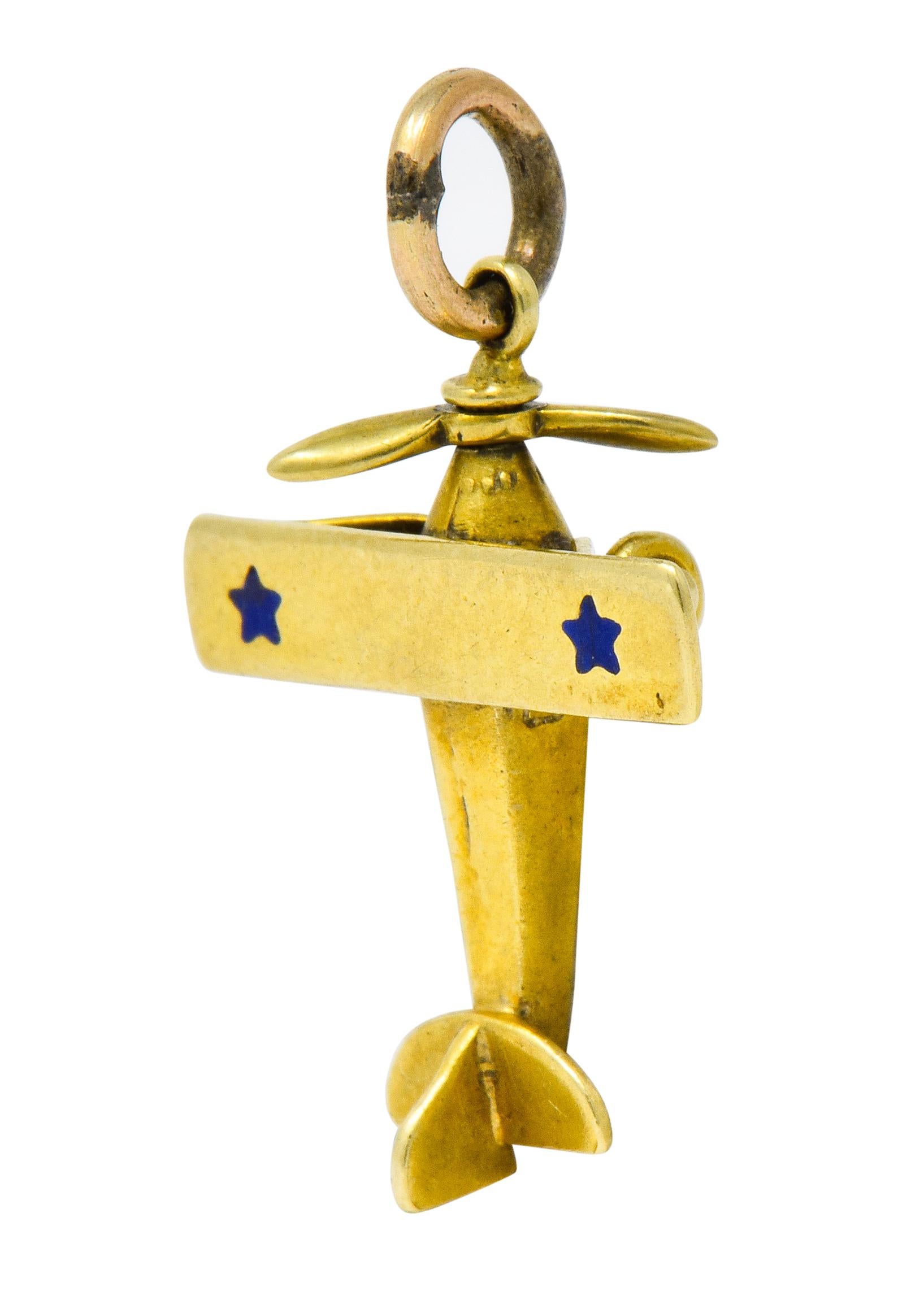 Charm designed as a whimsical plane featuring an articulated propeller

With wide rectangular wings decorated with two bright blue enamel stars exhibiting no loss; consistent with age, wear, and use

Completed by jump ring bale

With maker's mark