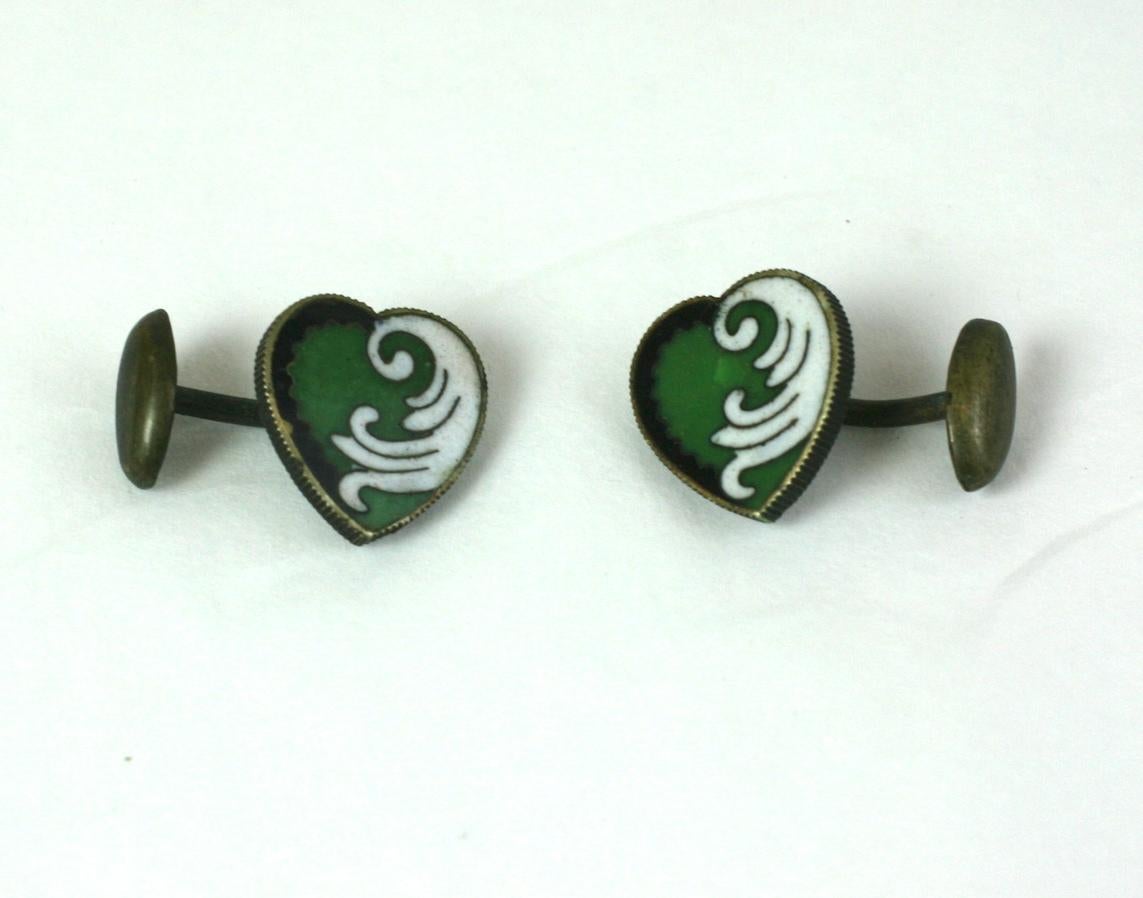 Unusual Art Nouveau Enamel Heart Cufflinks in brass with vibrant green, white and black designs. 
Back of heart is enameled in black as well. Elegant ribbed edge settings. Circa 1910. 
.5