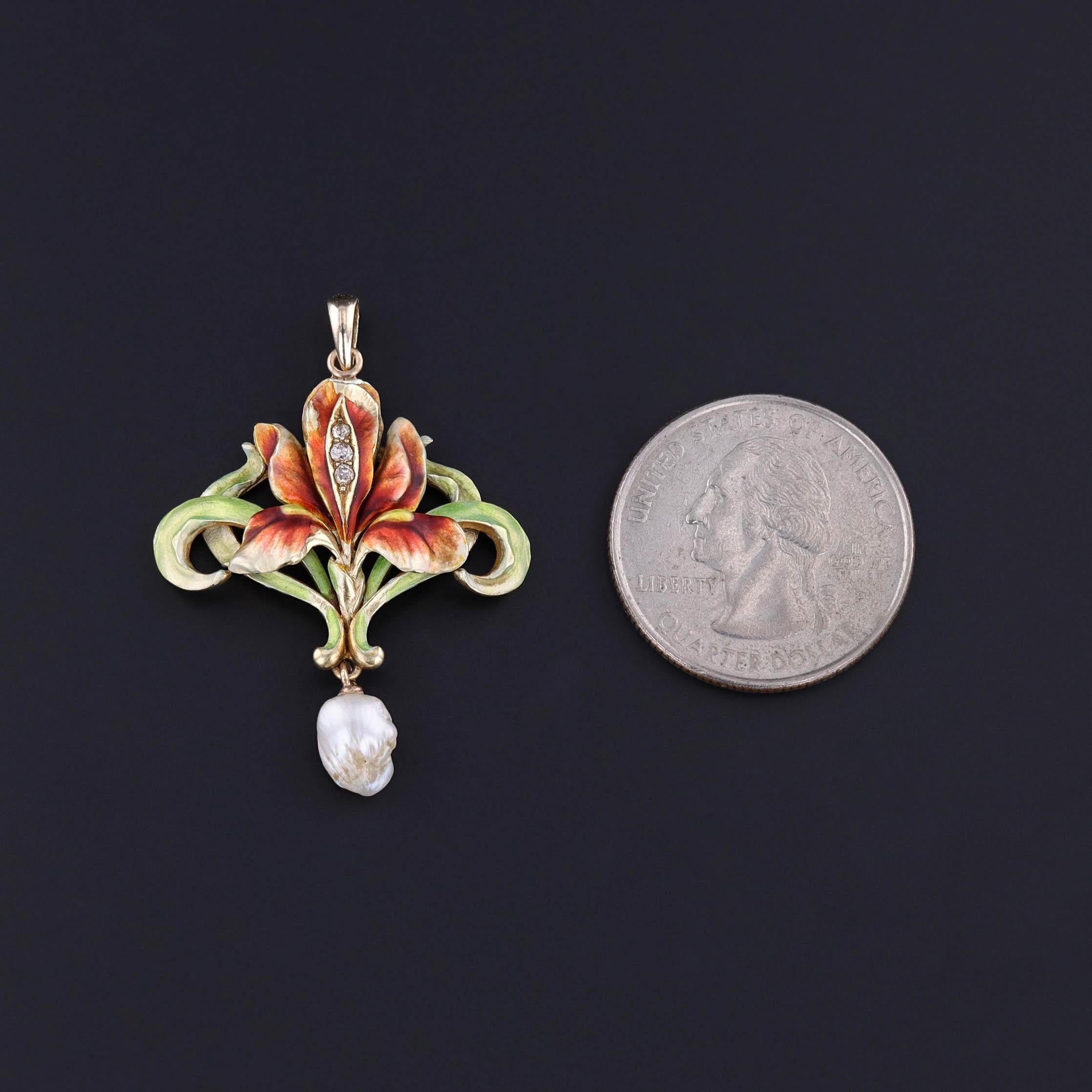 Antique Iris Pendant: This Art Nouveau era 14k gold pendant features an iris flower adorned with lustrous green and red enamel and three diamond accents. A baroque pearl dangles beneath the piece. The pendant was originally an antique brooch (circa