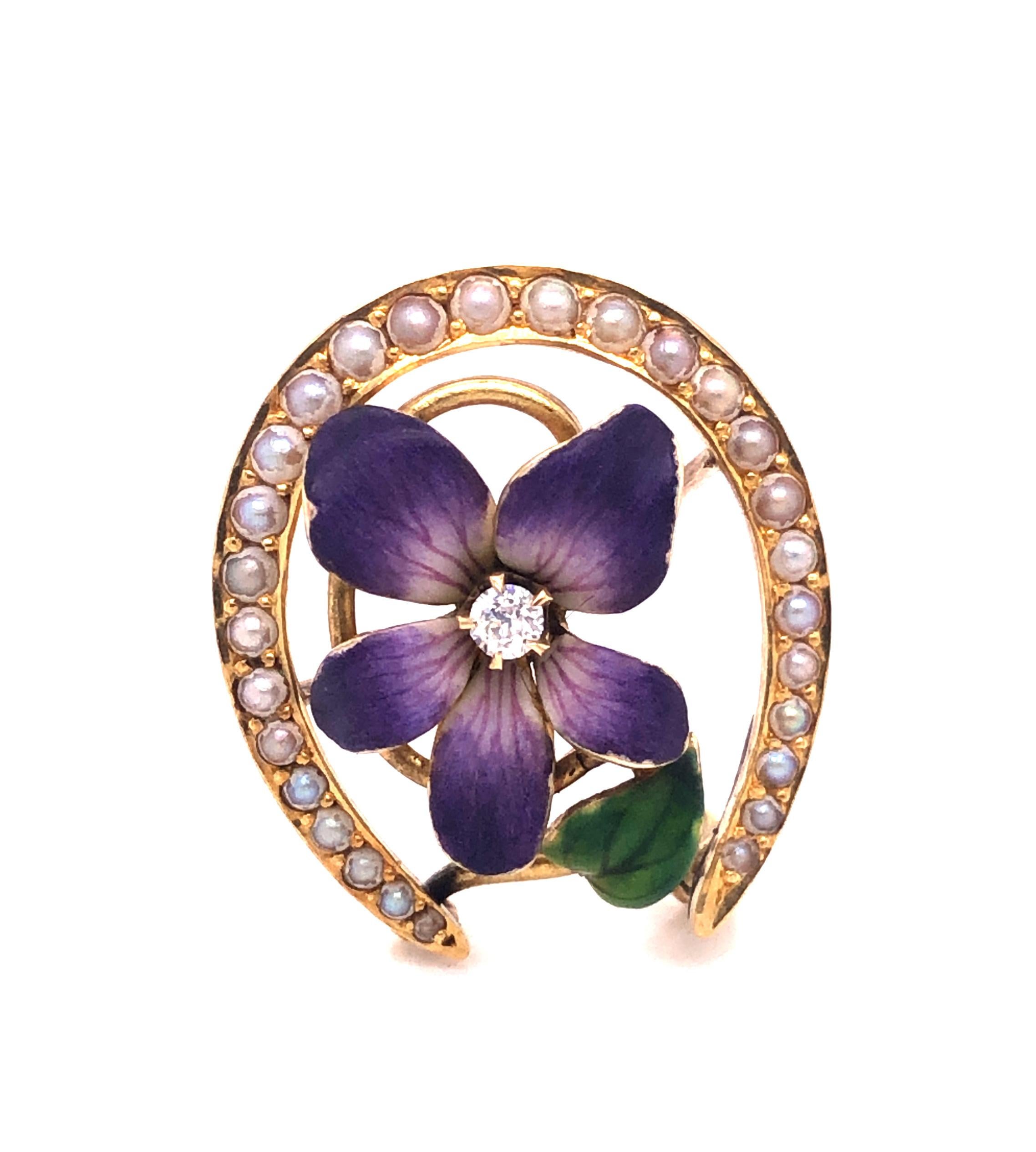 Dating from turn of-the-last-century, a fabulous purple pansy pendant/brooch centered with a sparkling antique round cut diamond. Lavender and white enamel detail the pansy making this piece pop with color. The overlapping petals are colored green