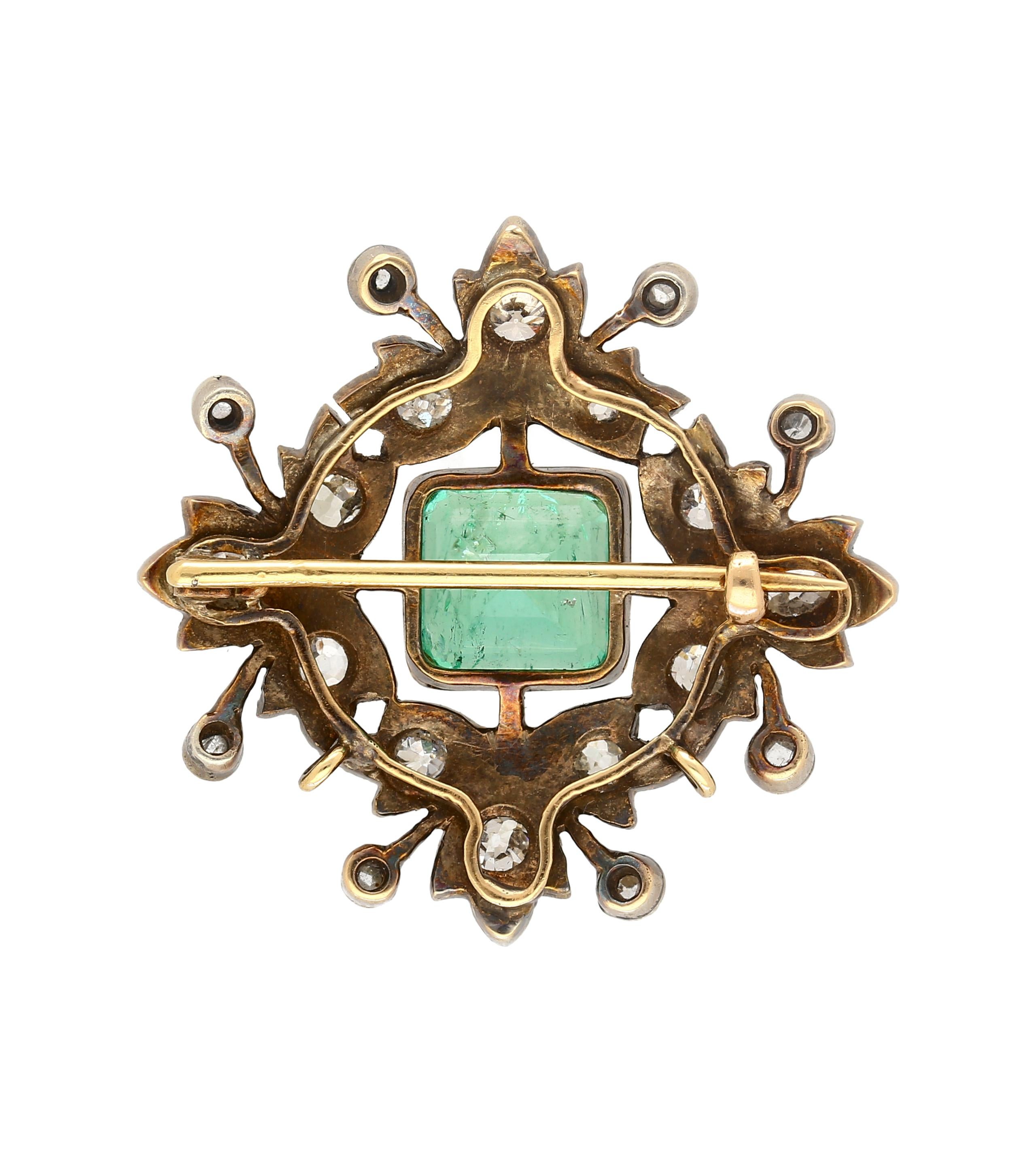 AGL certified emerald brooch, crafted from silver and gold with a weight of 8.12 grams. The centerpiece boasts a bezel set 3.12 Carat No oil cushion square cut natural Colombian Emerald, with origins from Colombia. Adorned by 20 Old European cut