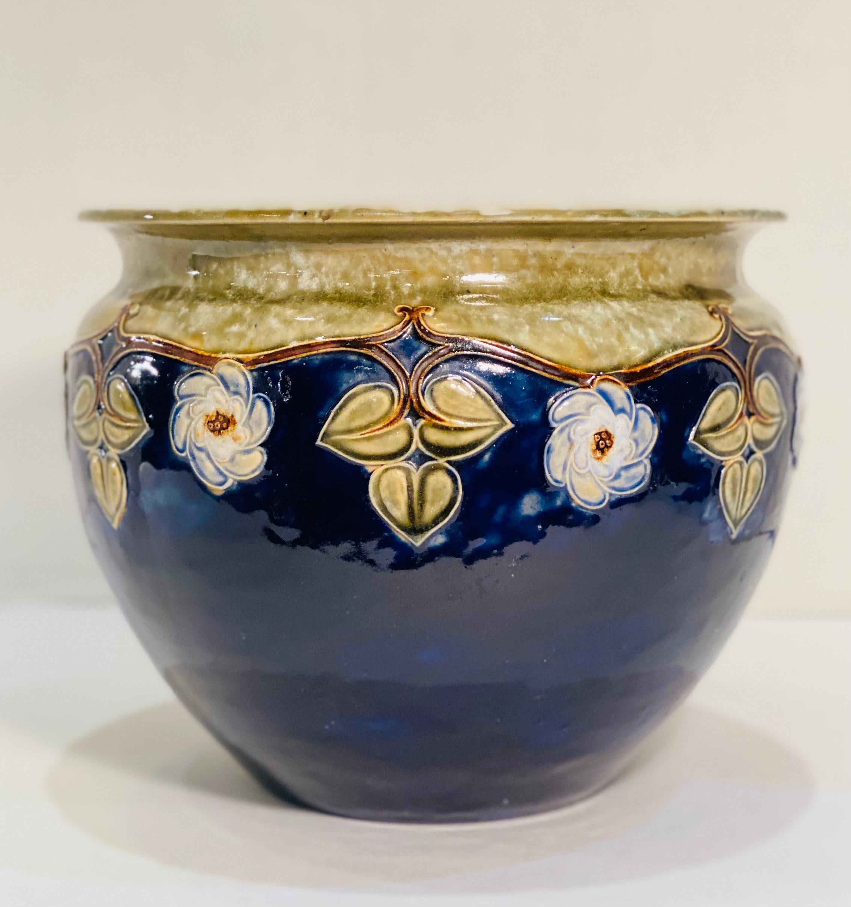 Beautiful hand made antique art pottery rimmed jardiniere pot or planter made by Royal Doulton factory of England. Circa approximately 1906 to 1910 in the period of Art Nouveau. This pot would also look great in an Arts and Crafts decor home or any