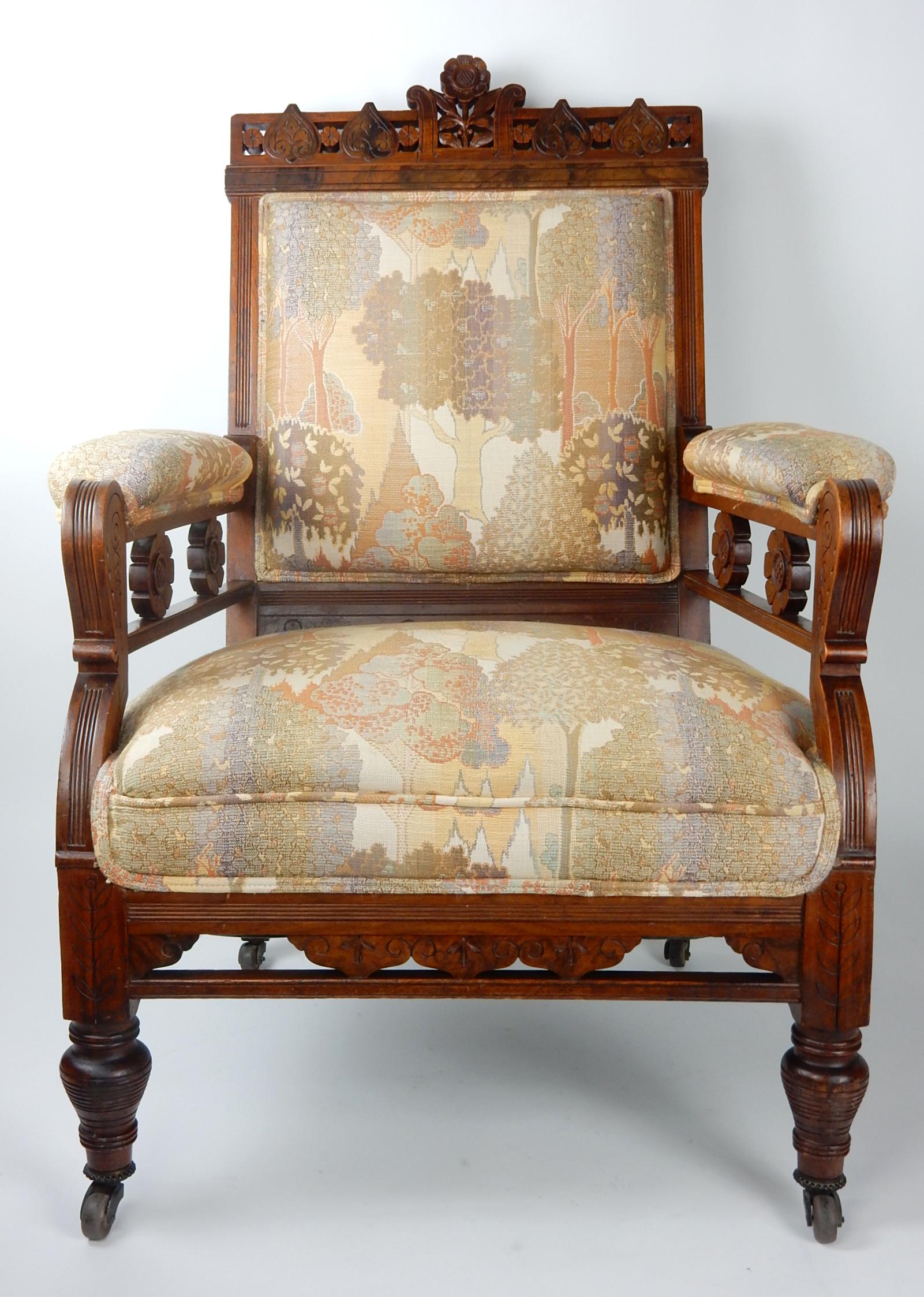 Late 19th century art chair with exquisitely carved floral design.
Upholstered in gorgeous Art Nouveau upholstery. 
Rolls on wooden casters. 
Solid chair with no alteration or repair.