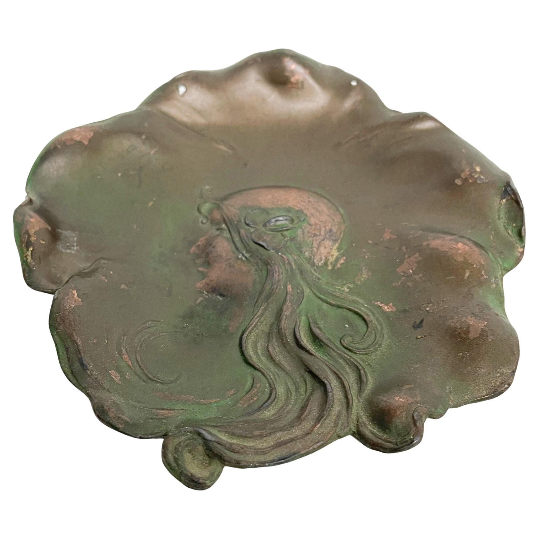 Art Nouveau Deco Fair Maiden Sculptural Leaf Dish - pretty face and flowing hair.
Signed and Dated April 4, 1906
5 diameter x .5
Original Unrestored Fair Vintage Condition - 2 small holes at top.  
Minor losses and minor fading.
See images