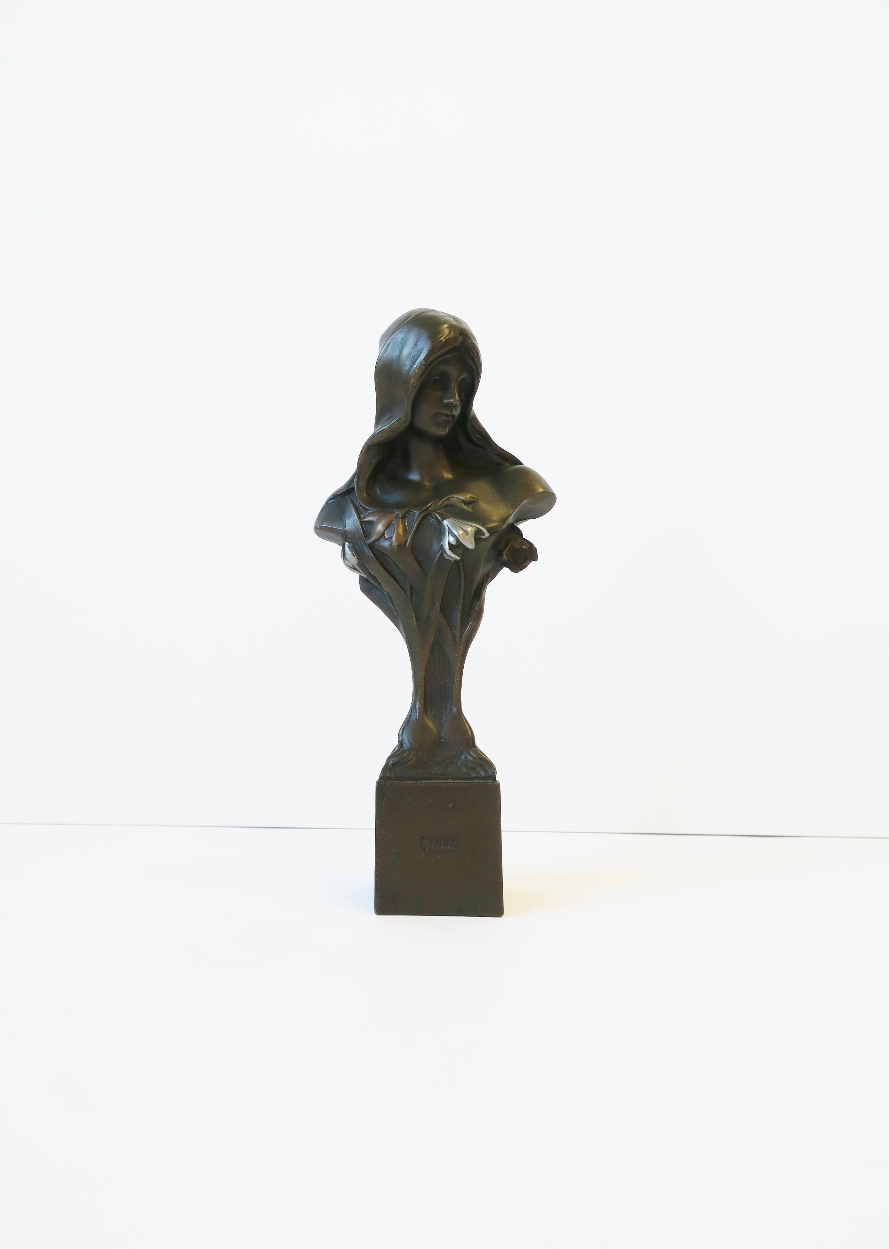 An Art Nouveau female bronze figurative bust sculpture of a young woman 