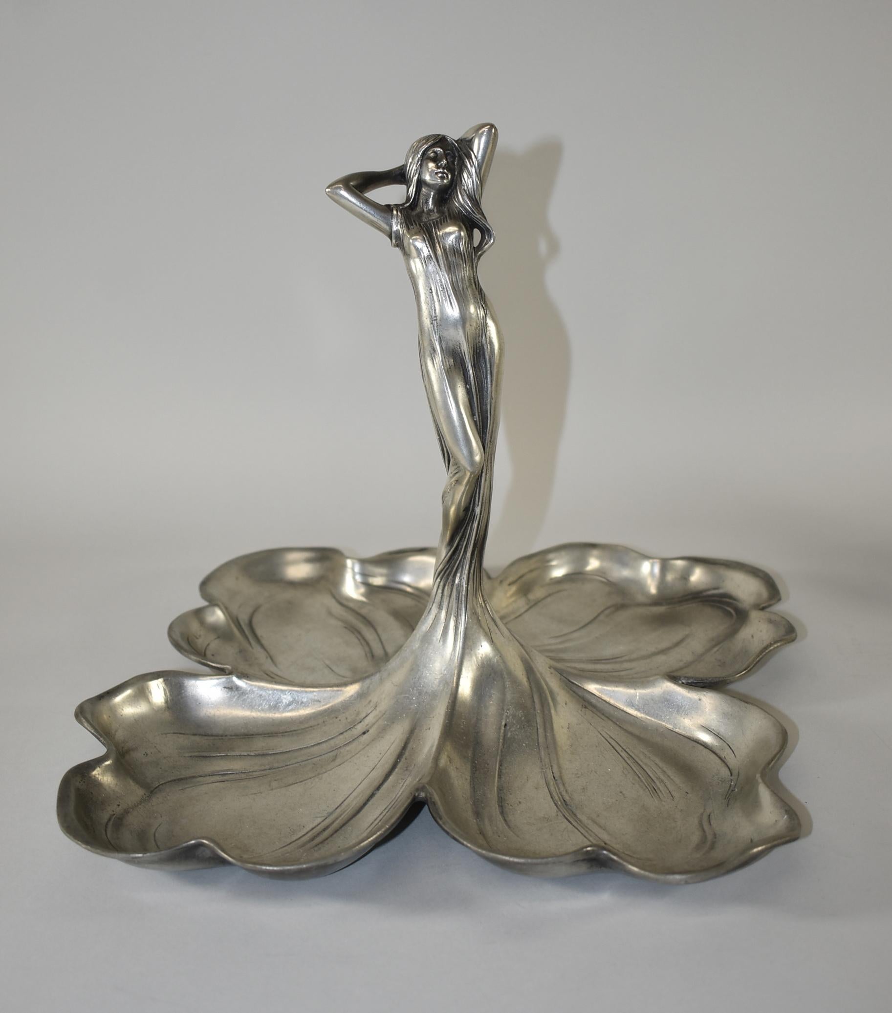 Art Nouveau pewter bowl / tray / fruit dish /centerpiece designed by Albert Mayer. It is an outstanding masterpiece with a figural young beauty with long flowing hair and dress that transforms into a quadruple leaf dish. The centerpiece quadruple