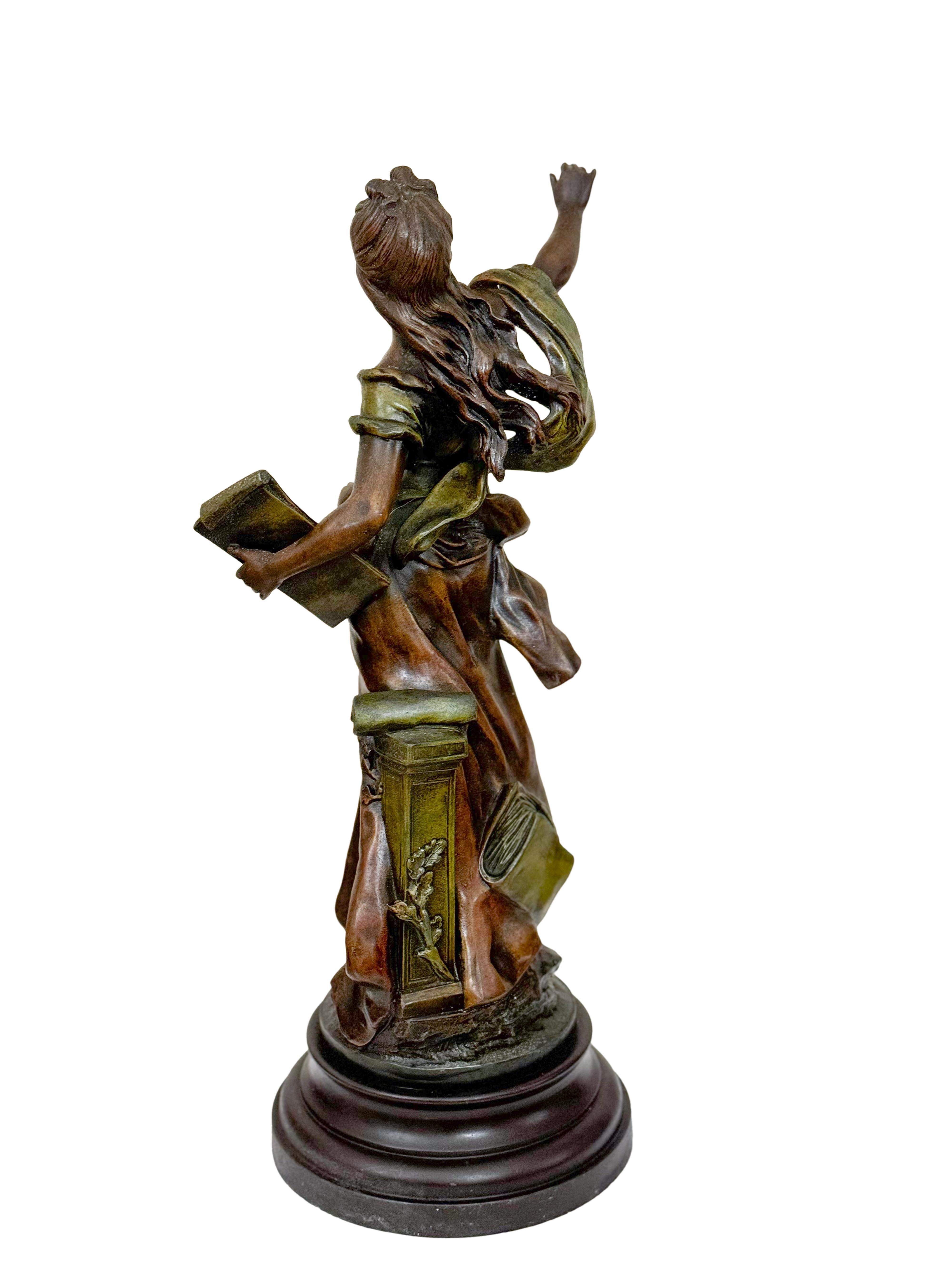 This Art Nouveau spelter figure, created by renowned sculptor Auguste Moreau (1834–1917), captures the elegance of an allegorical classical maiden. 
Draped in flowing attire, she gracefully extends her right arm while cradling a scroll in her left,
