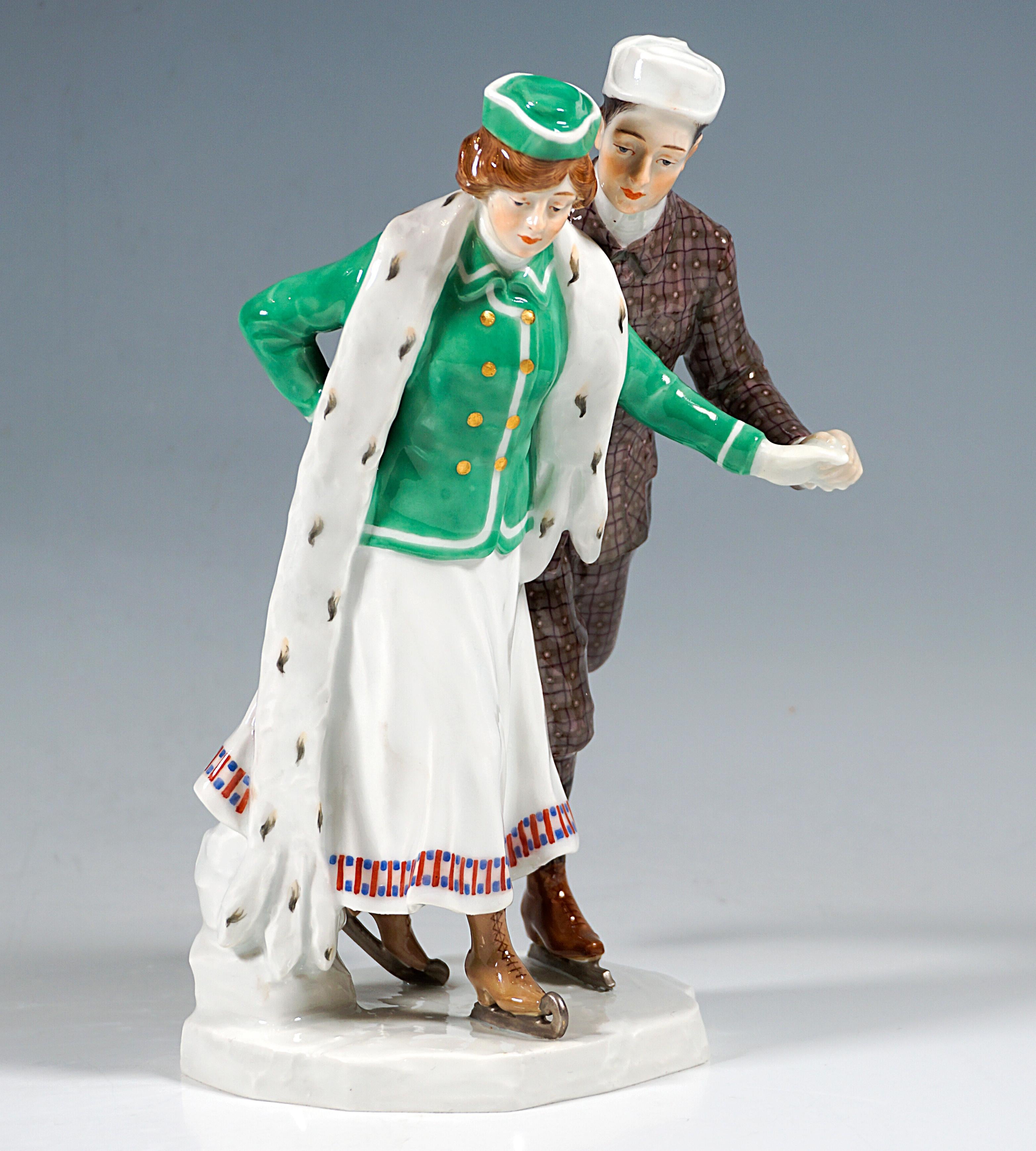 Extremely rare Meissen Art Nouveau porcelain group:
Ice-skating couple in elegant winter clothing: the lady in a long, white skirt with a colorfully decorated hem, a green jacket with white hems and a matching cap and long ermine scarf, the gallant
